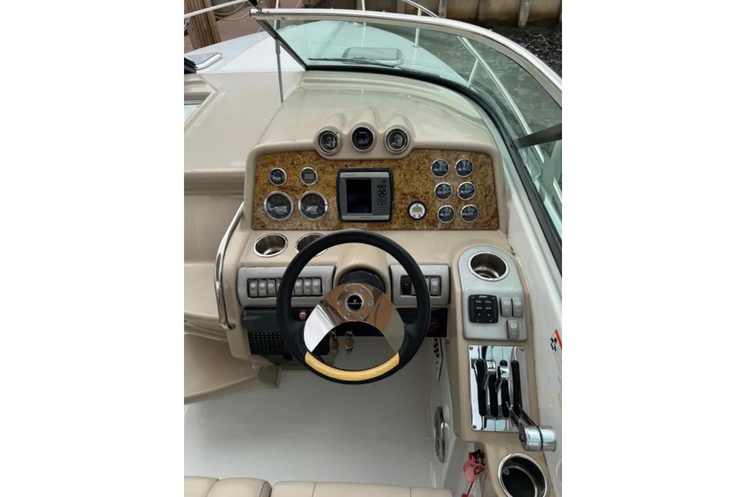 2010 Formula 310 Sun Sport boat dashboard with steering wheel and control panel.