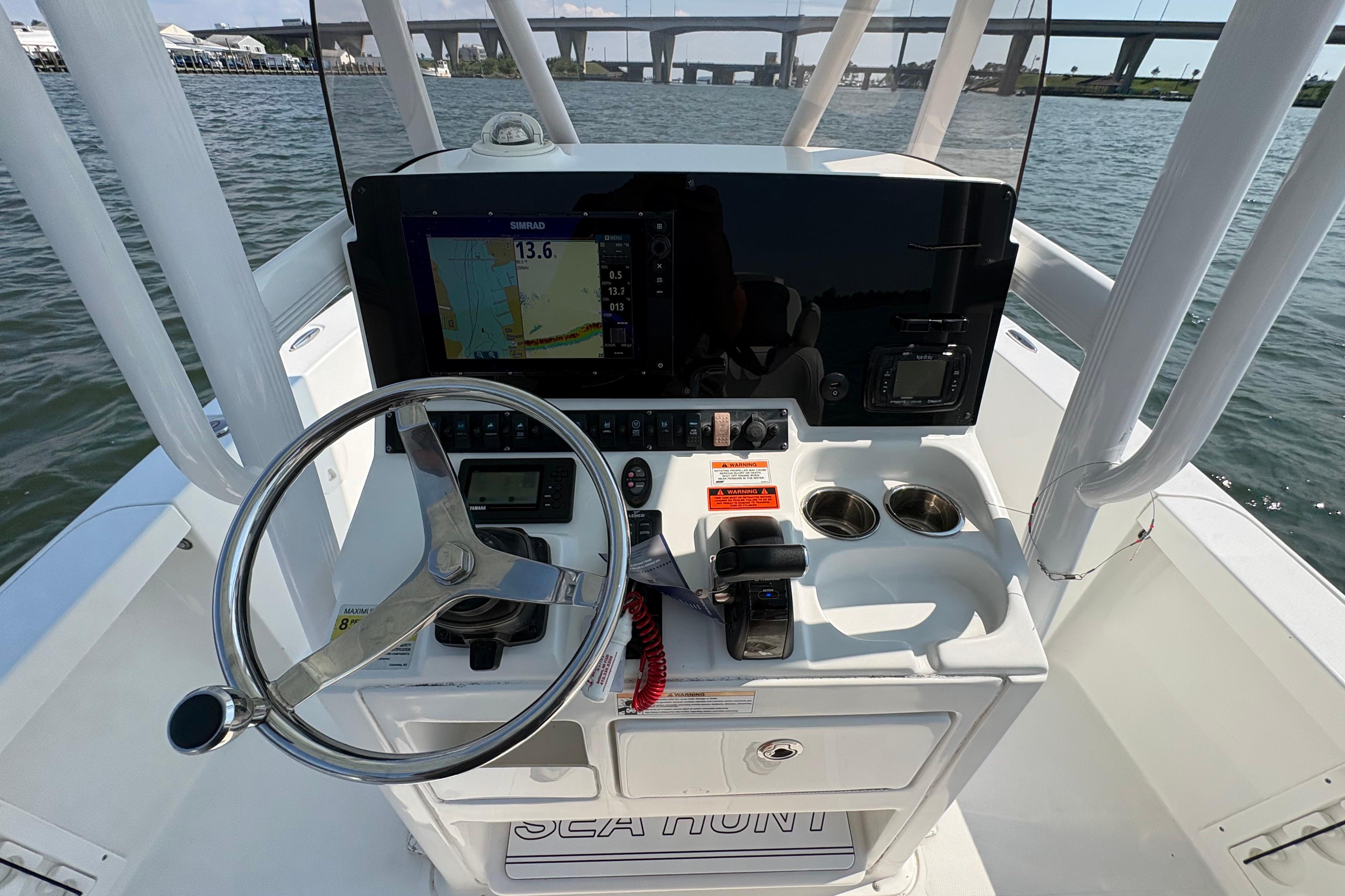 2017 Sea Hunt BX 25 BR boat dashboard with steering wheel and navigation system.