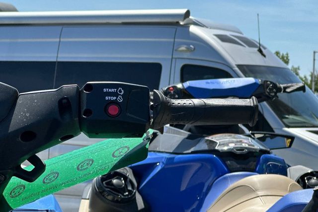 Close-up of a Yamaha WaveRunner JETBLASTER-BLACK with start/stop button and handlebars.