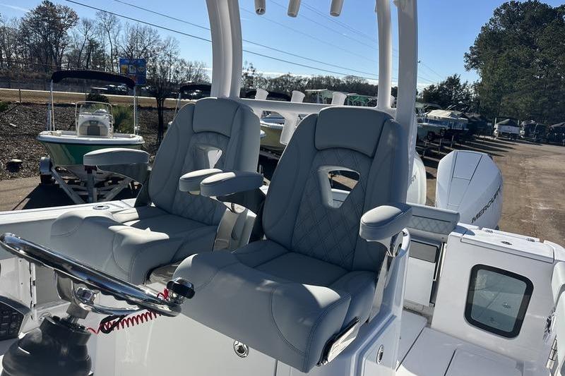 2026 Sportsman Open 282 Center Console boat with dual captain's chairs and steering wheel.