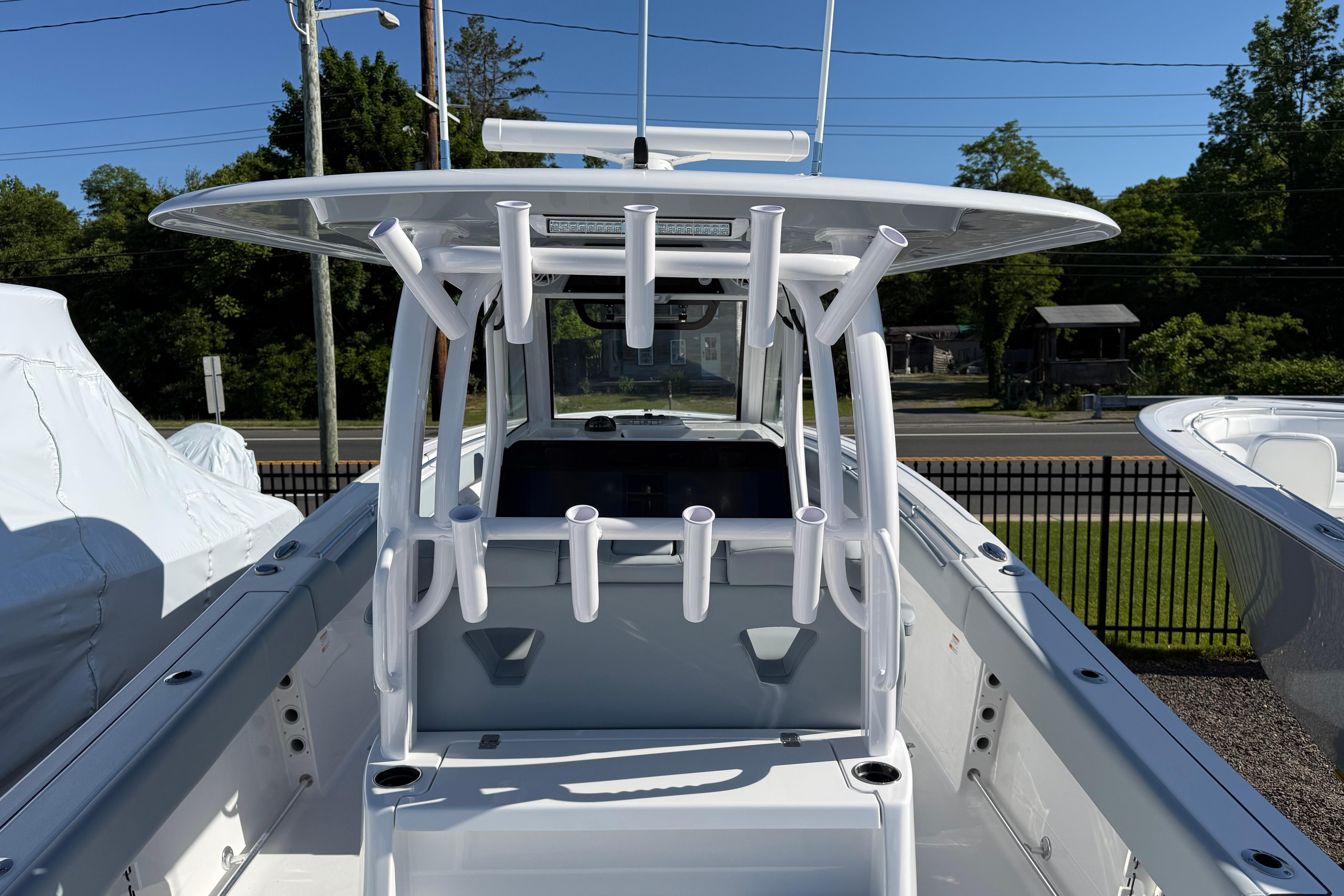 2026 Sportsman Open 322 Center Console boat with rod holders, viewed from the rear.