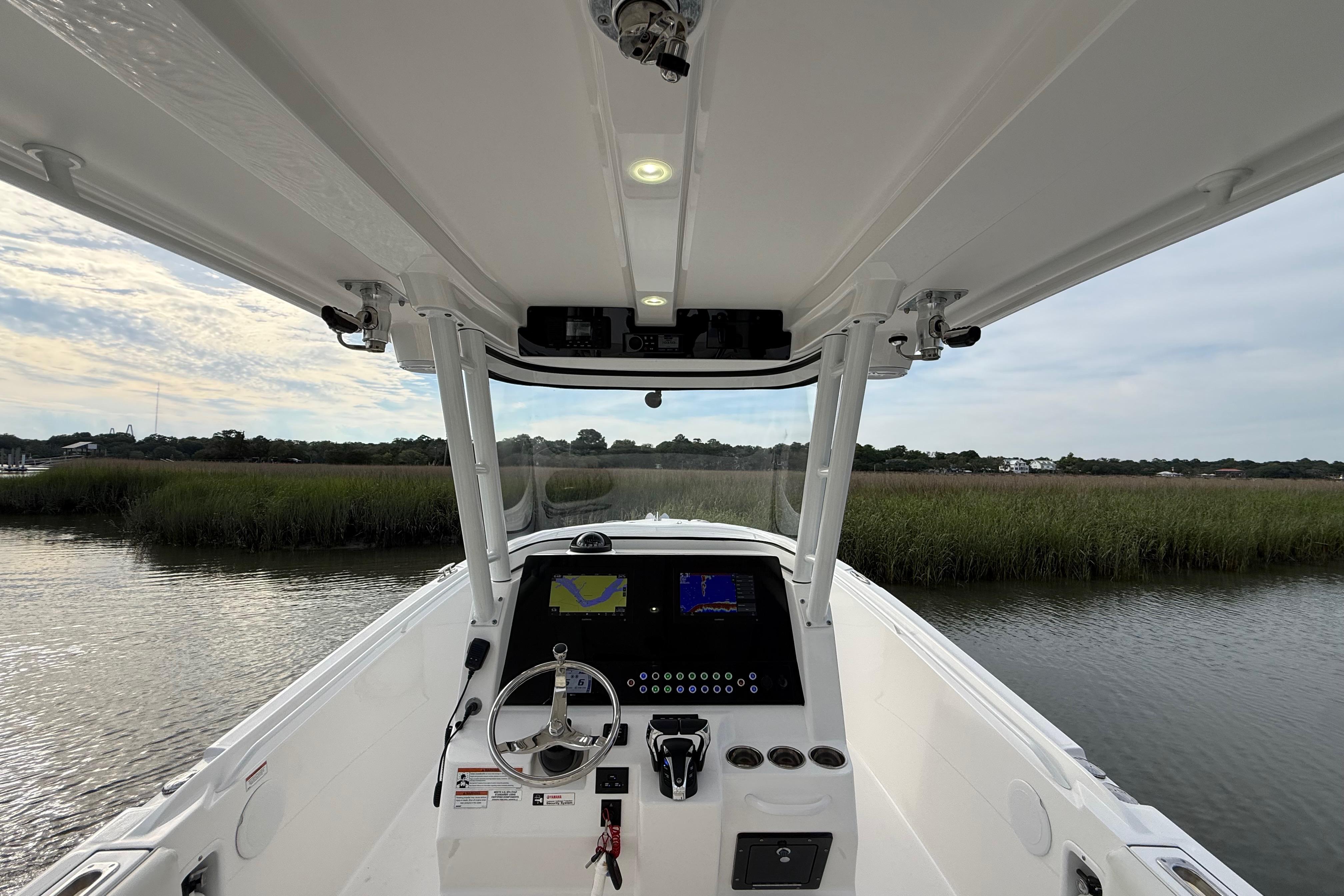 2022 Edgewater 280CC boat cockpit with modern navigation system on calm water.