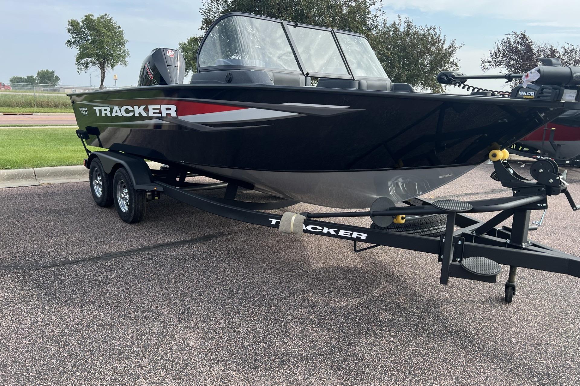 2025 Tracker Targa V-18 Combo boat on trailer, parked outdoors.