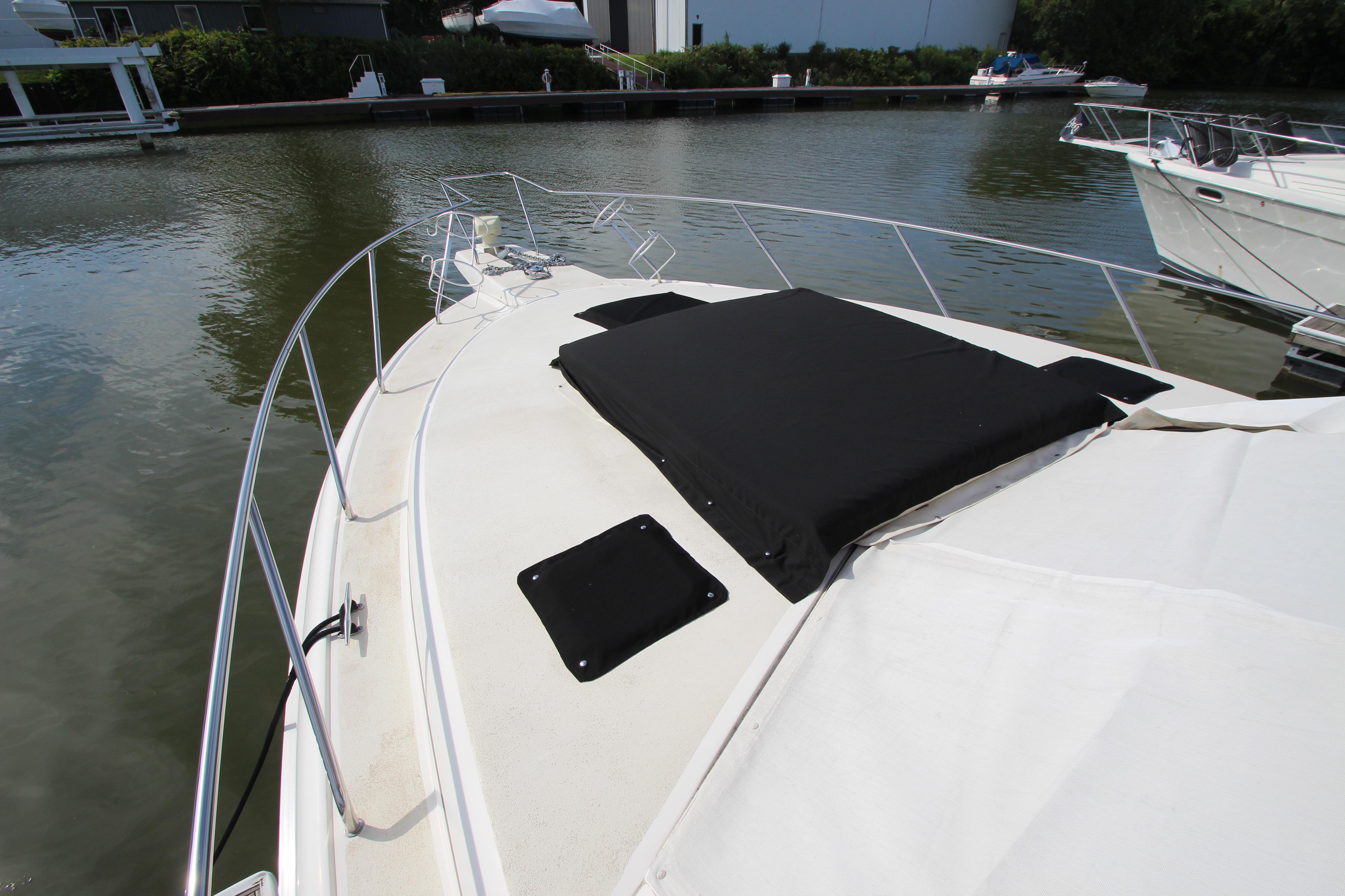 2000 Silverton 37 Convertible yacht docked, featuring spacious deck and sleek design.