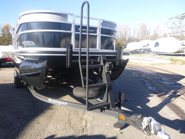 2024 Ranger Reata 223C pontoon boat on trailer in outdoor setting.