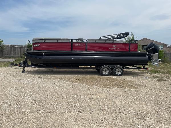 2023 Regency 250DL3 pontoon boat on trailer, parked outdoors.