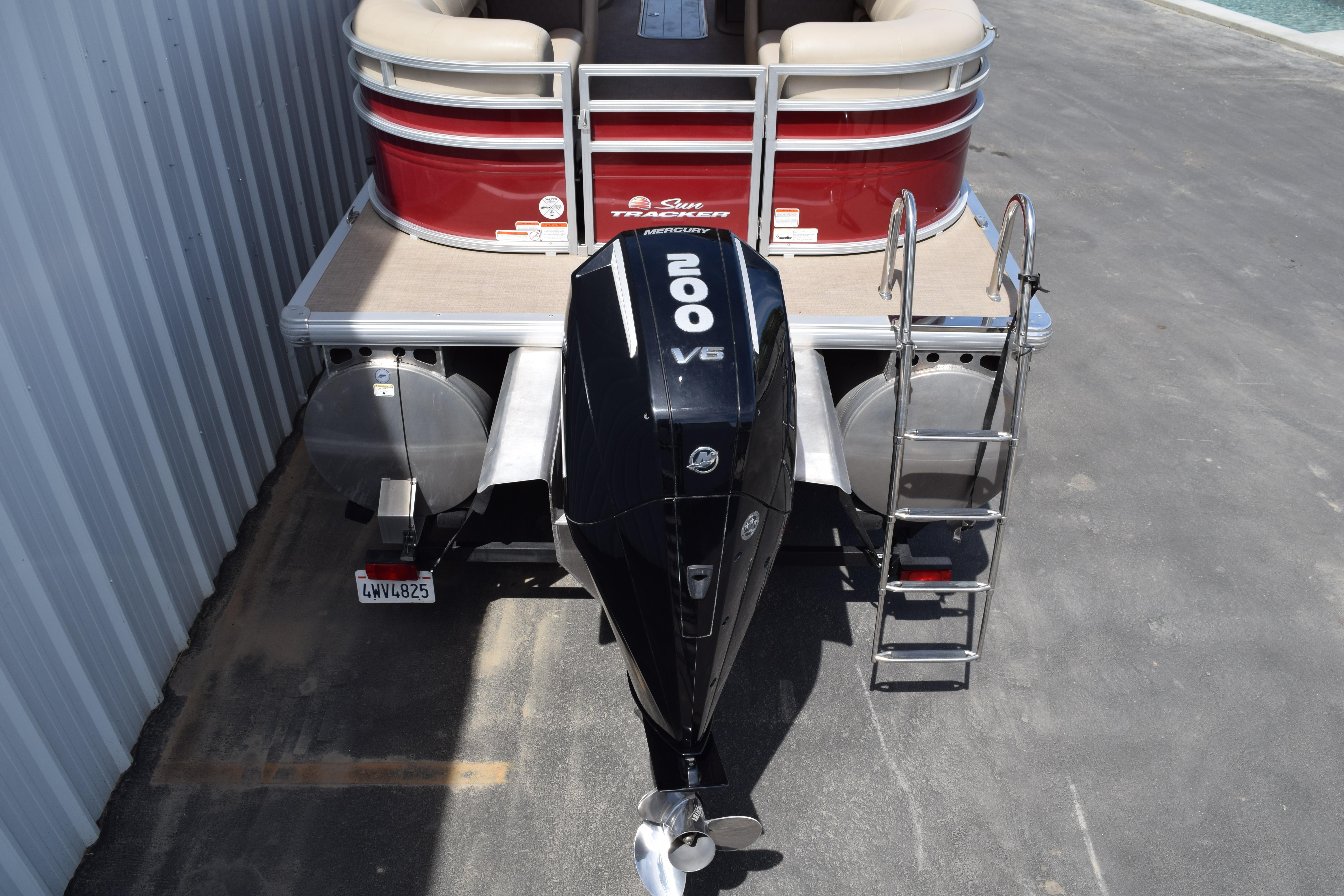 2025 Sun Tracker Party Barge 22 XP3 with Mercury 200 V6 engine, docked.