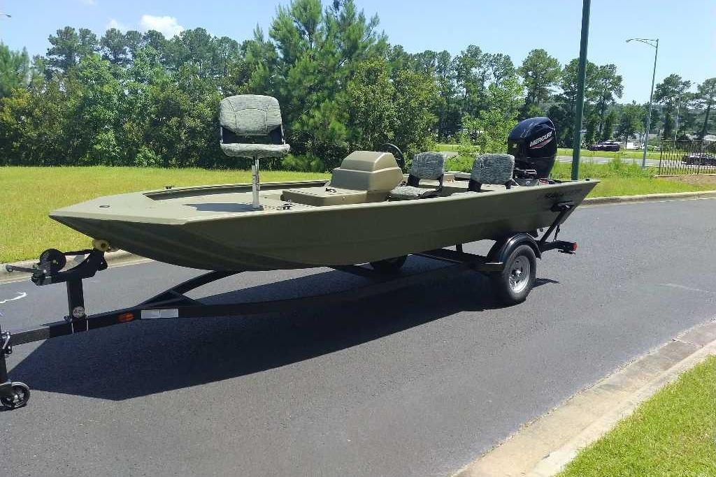 2026 Tracker Grizzly 1754 SC boat on trailer, parked on a sunny road.