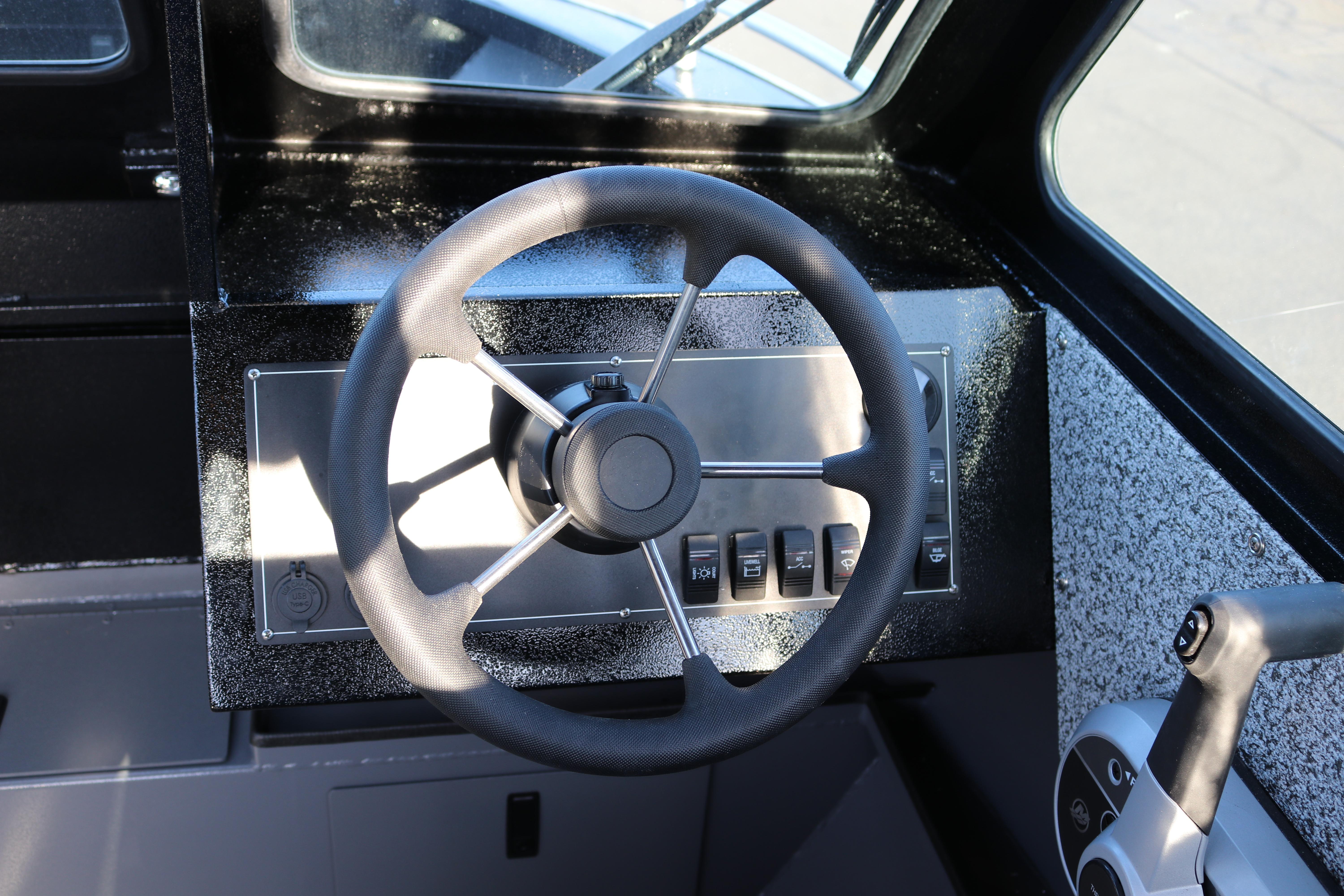 Steering wheel and controls of 2026 Alumaweld Stryker X202 boat.
