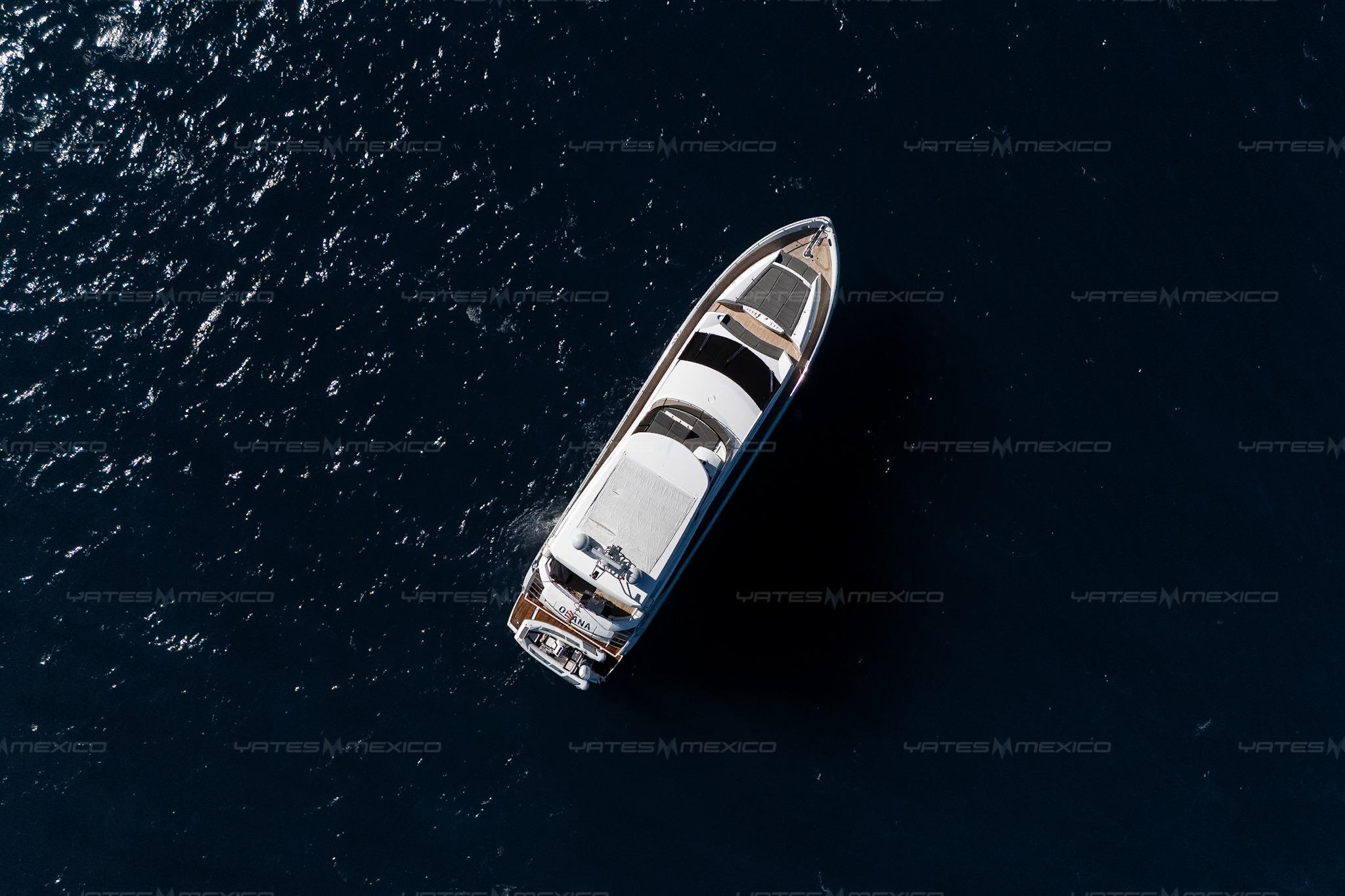Aerial view of 2015 Sunseeker 75 Yacht cruising on dark blue ocean waters.