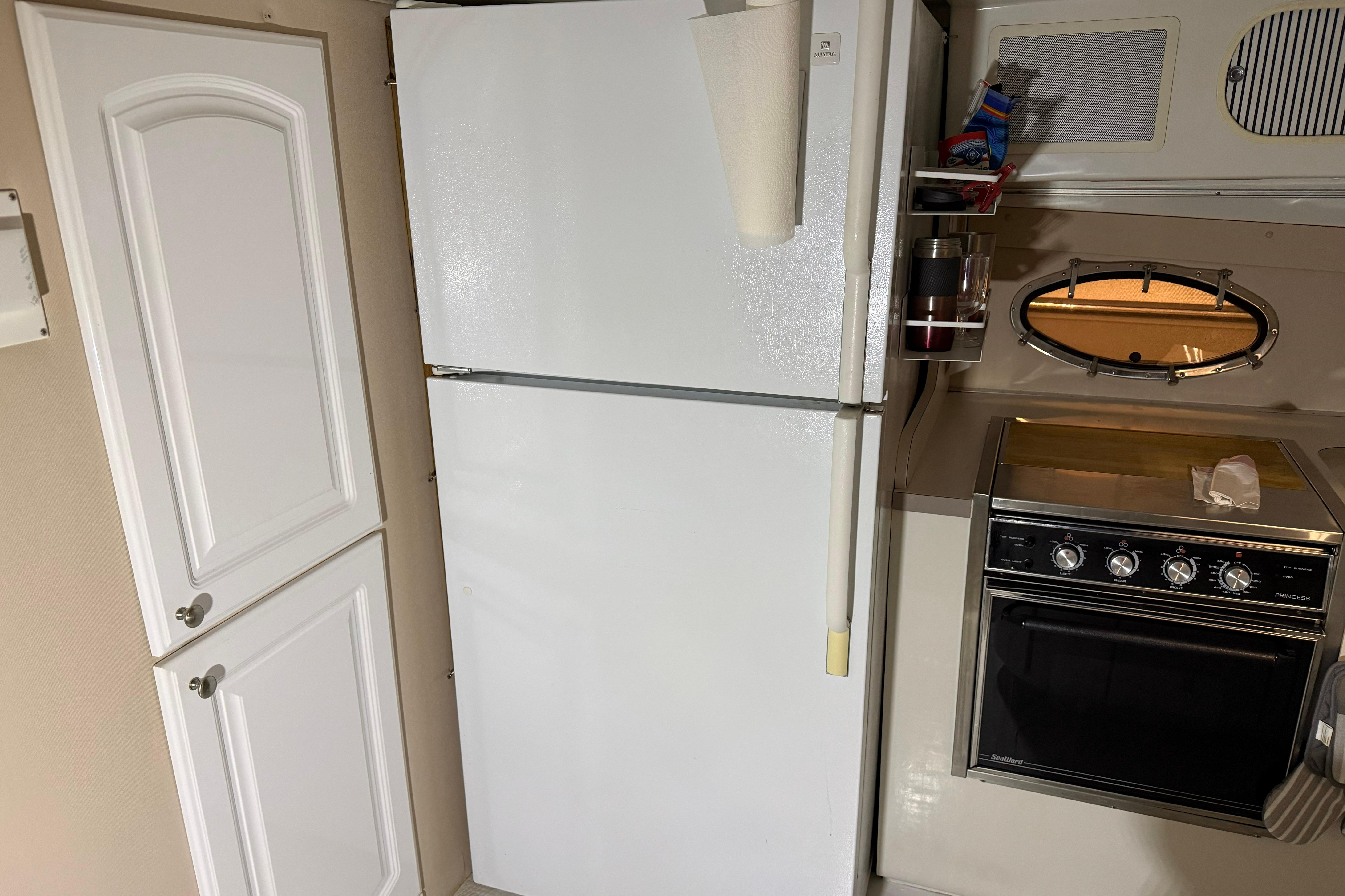 Kitchen area of 1988 Trojan 13 Meter Express 430 with fridge and stove.