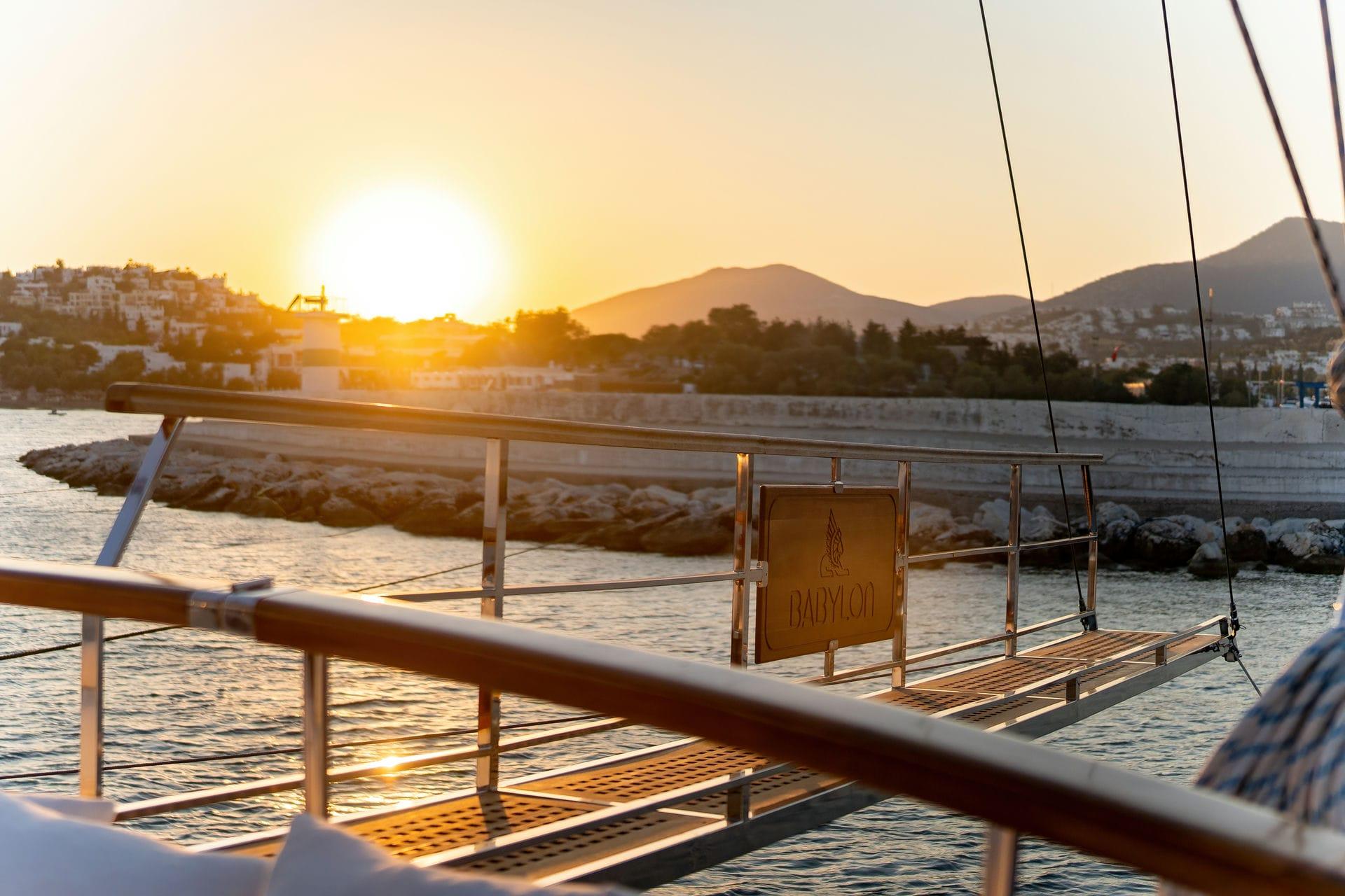 Sunset view from a Custom 134 yacht, 2015, overlooking serene coastal landscape.