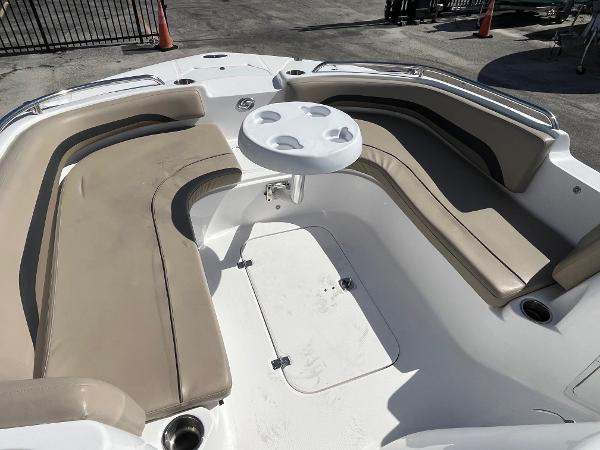 2022 Hurricane Center Console SS 231 OB boat with beige seating and round table.