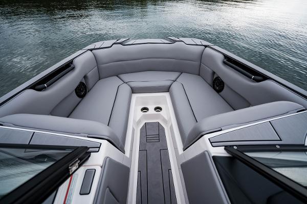 Manufacturer Provided Image: 2026 Moomba Max boat interior with gray seating, cup holders, and water view.