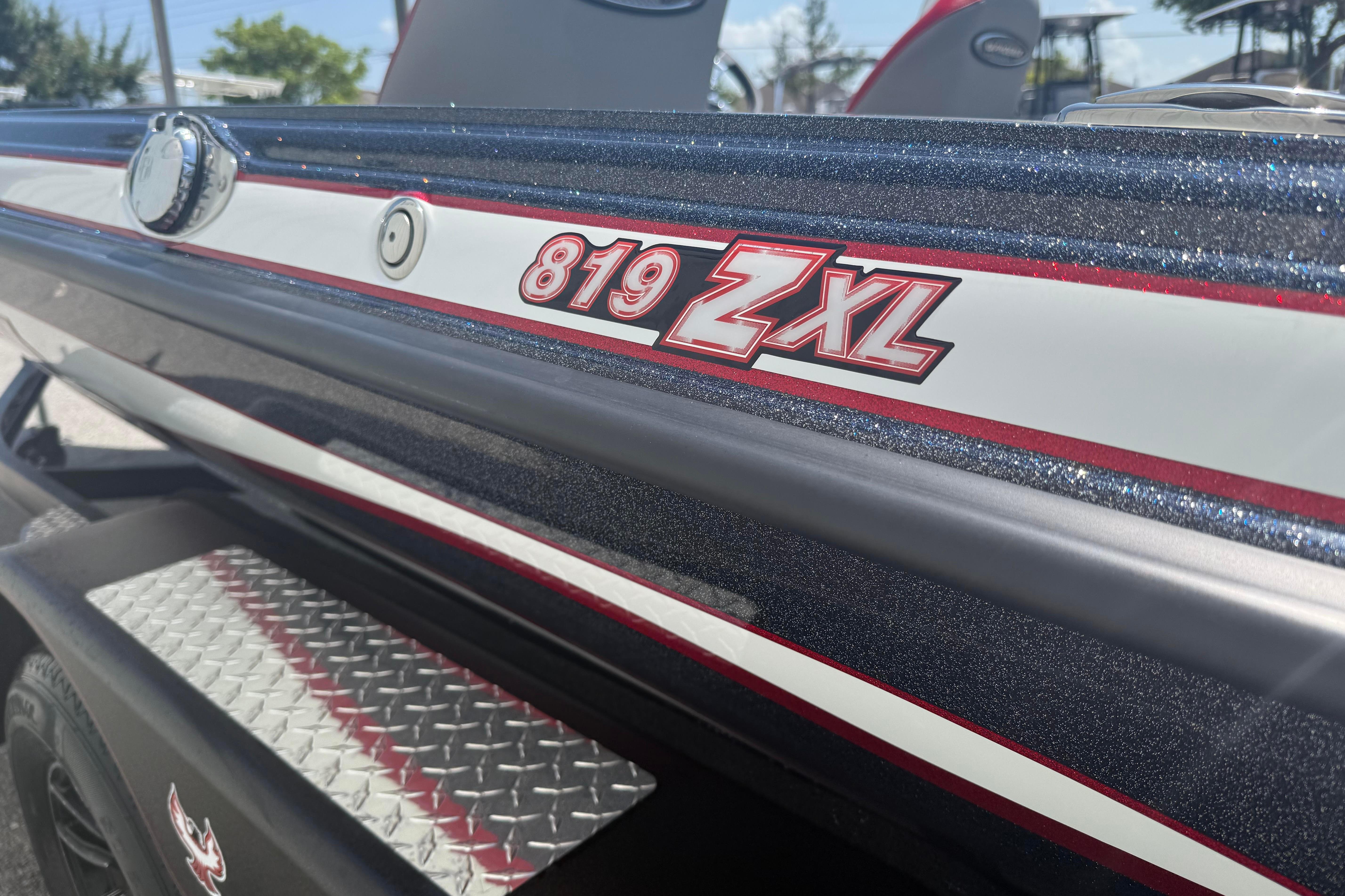 Close-up of 2027 Phoenix 819 ZXL boat with metallic finish and logo.