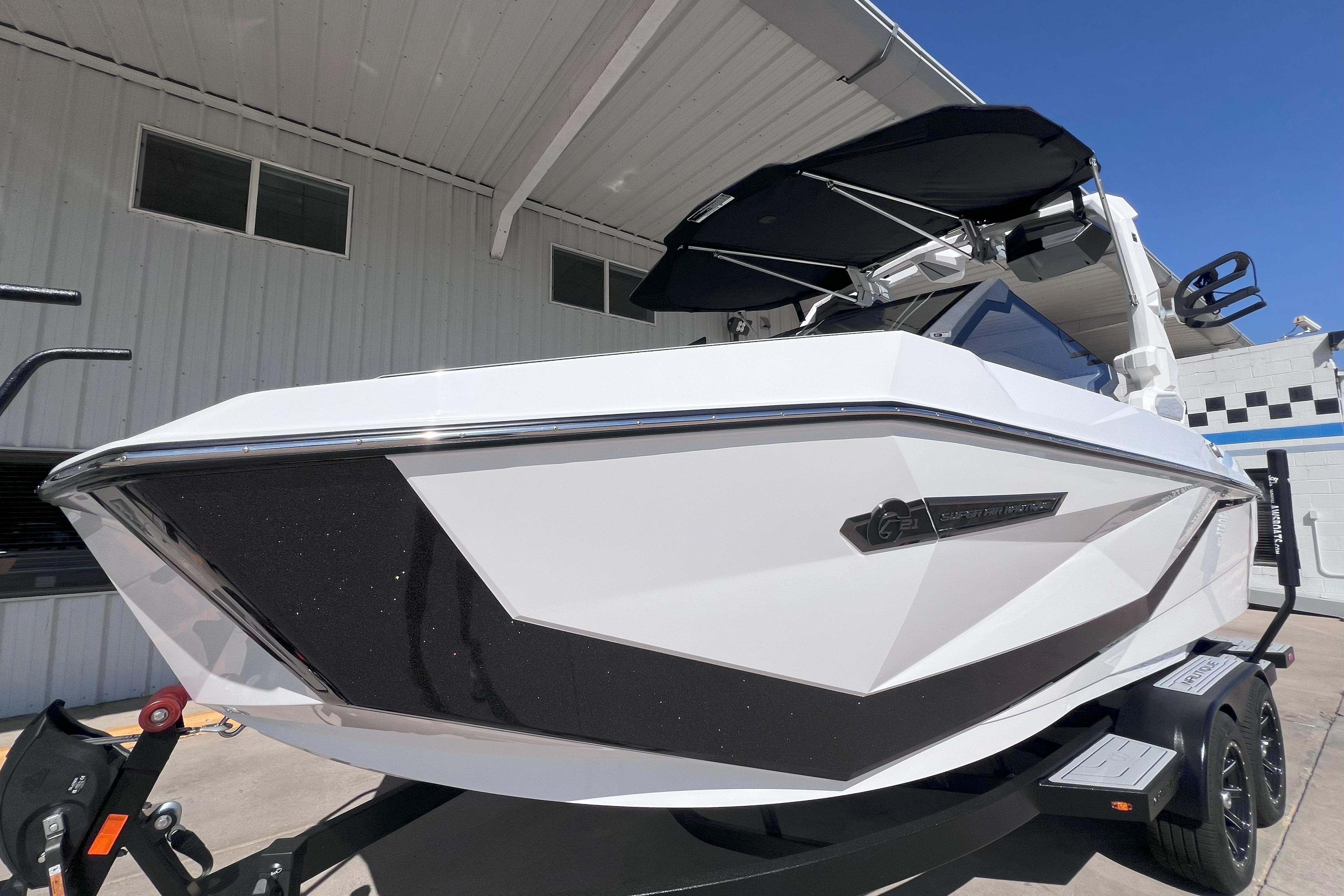 2025 Nautique Super Air Nautique G21 boat with sleek design, parked outdoors.