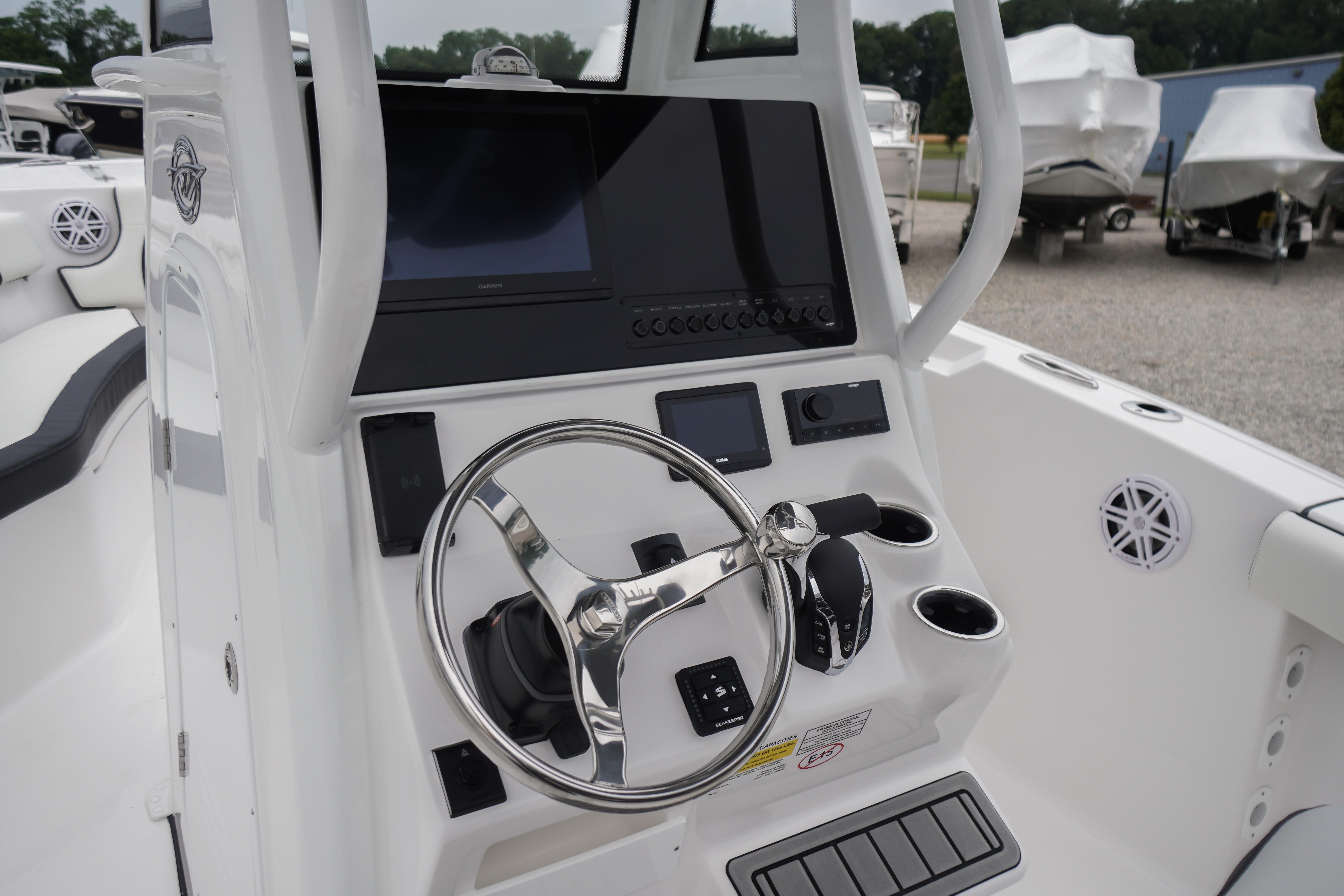 2026 Tidewater 232 SS boat console with steering wheel and control panel.