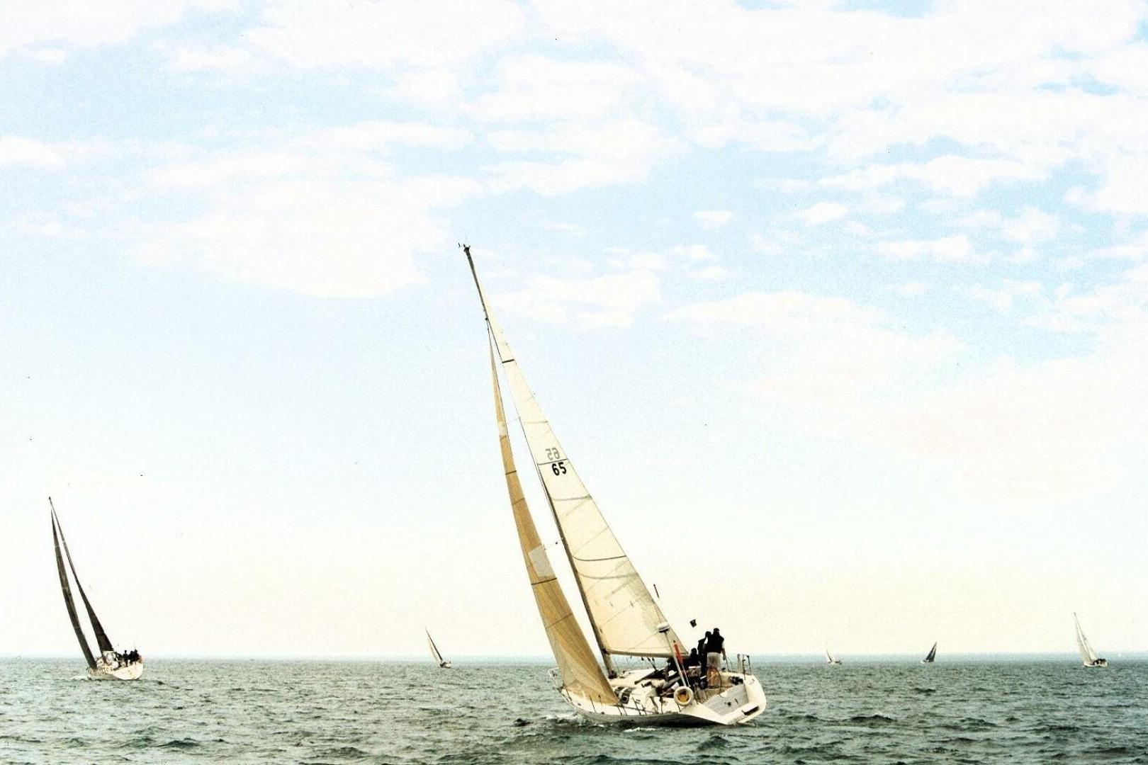 Sailboats racing on open sea, featuring a 1989 Beneteau First 35s5.