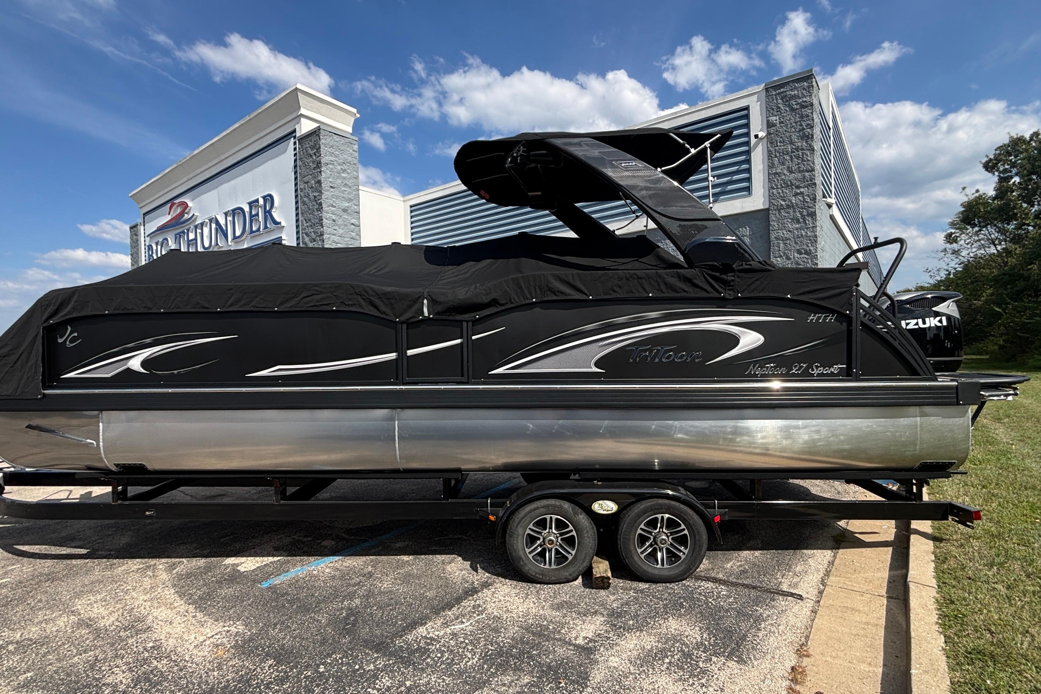 2026 JC NEPTOON 27TT SPORT pontoon boat with black cover, parked at dealership.