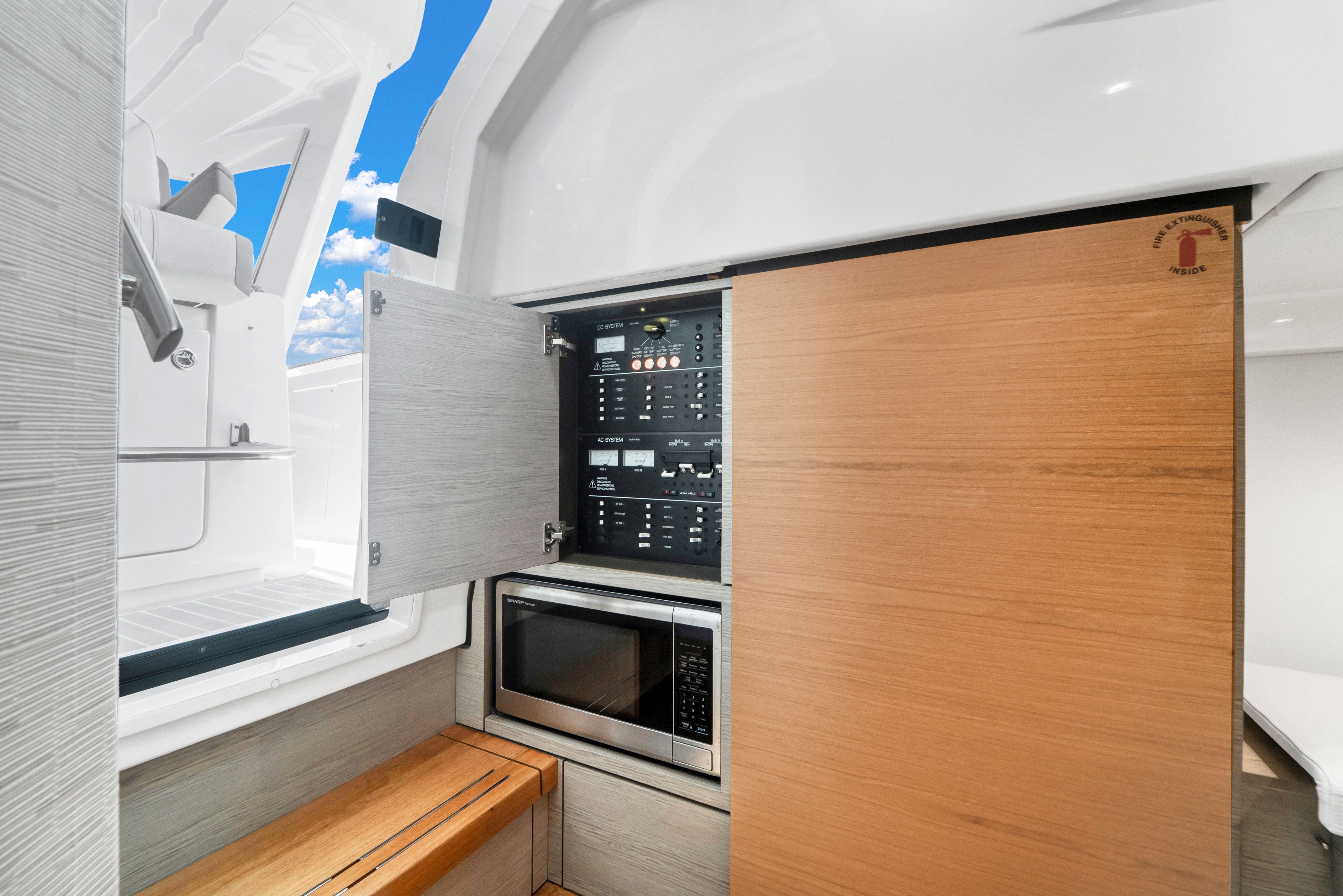 Interior of a 2023 Tiara Yachts 38 LS with a microwave and control panel.