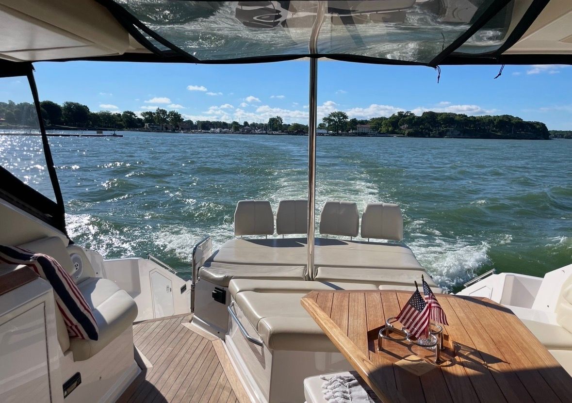 Regal 52 Sport Coupe 2010 cruising with American flag on table.