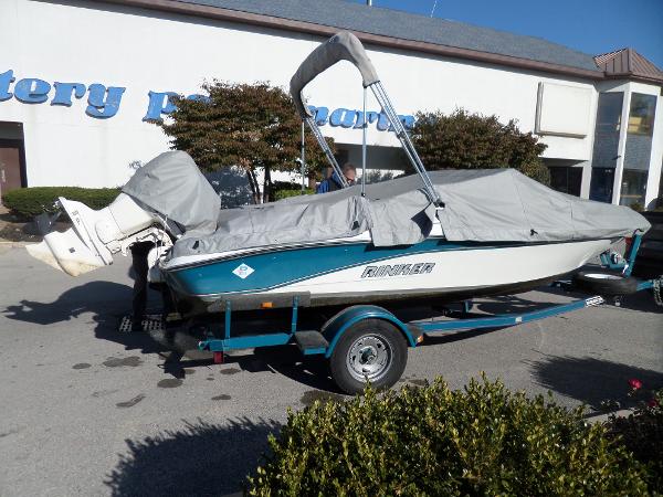 1992 Rinker Captiva 170 OB boat on trailer, covered and parked outdoors.
