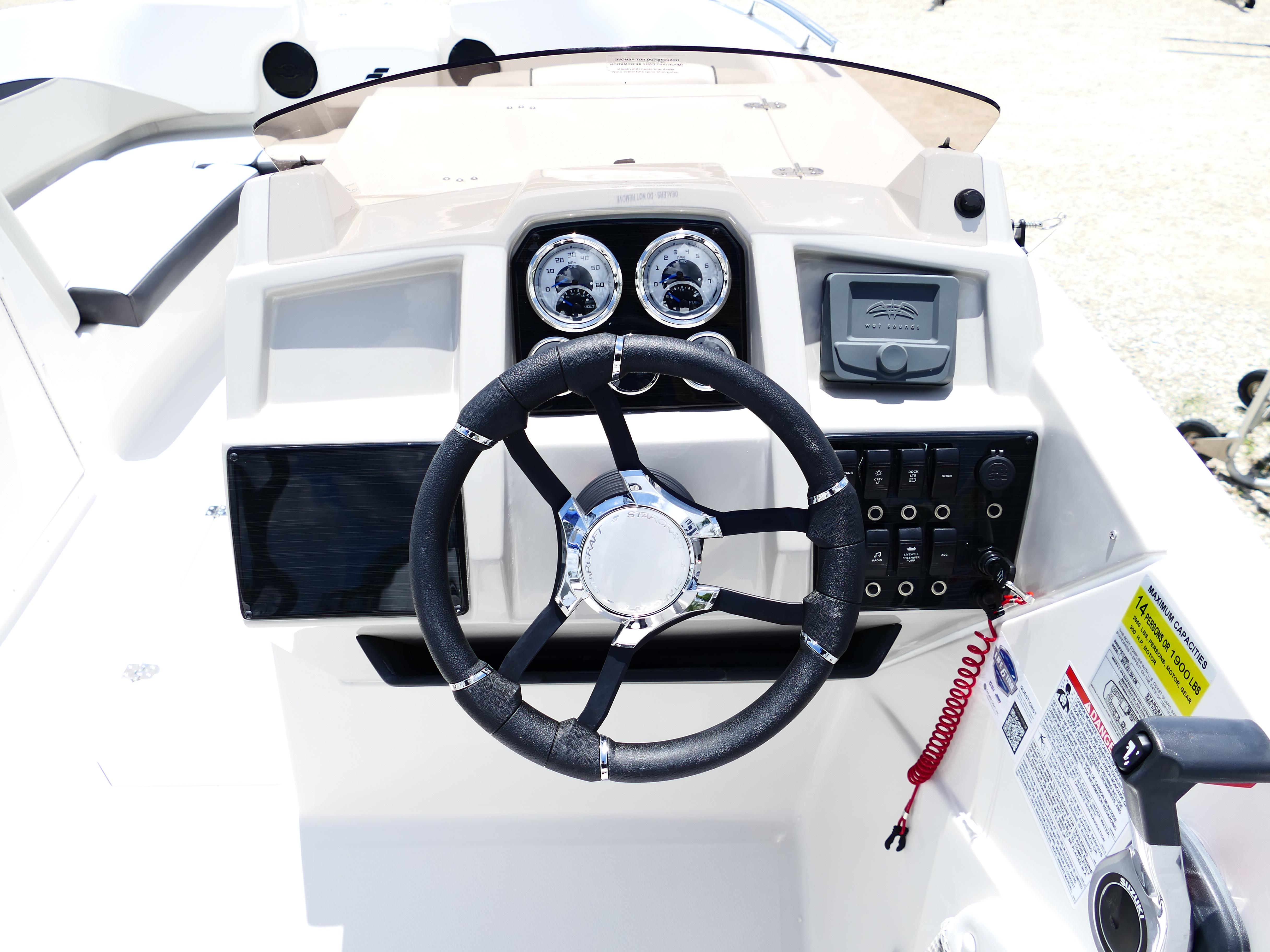 2026 Starcraft SVX 231 OB DH boat dashboard with steering wheel and control panel.