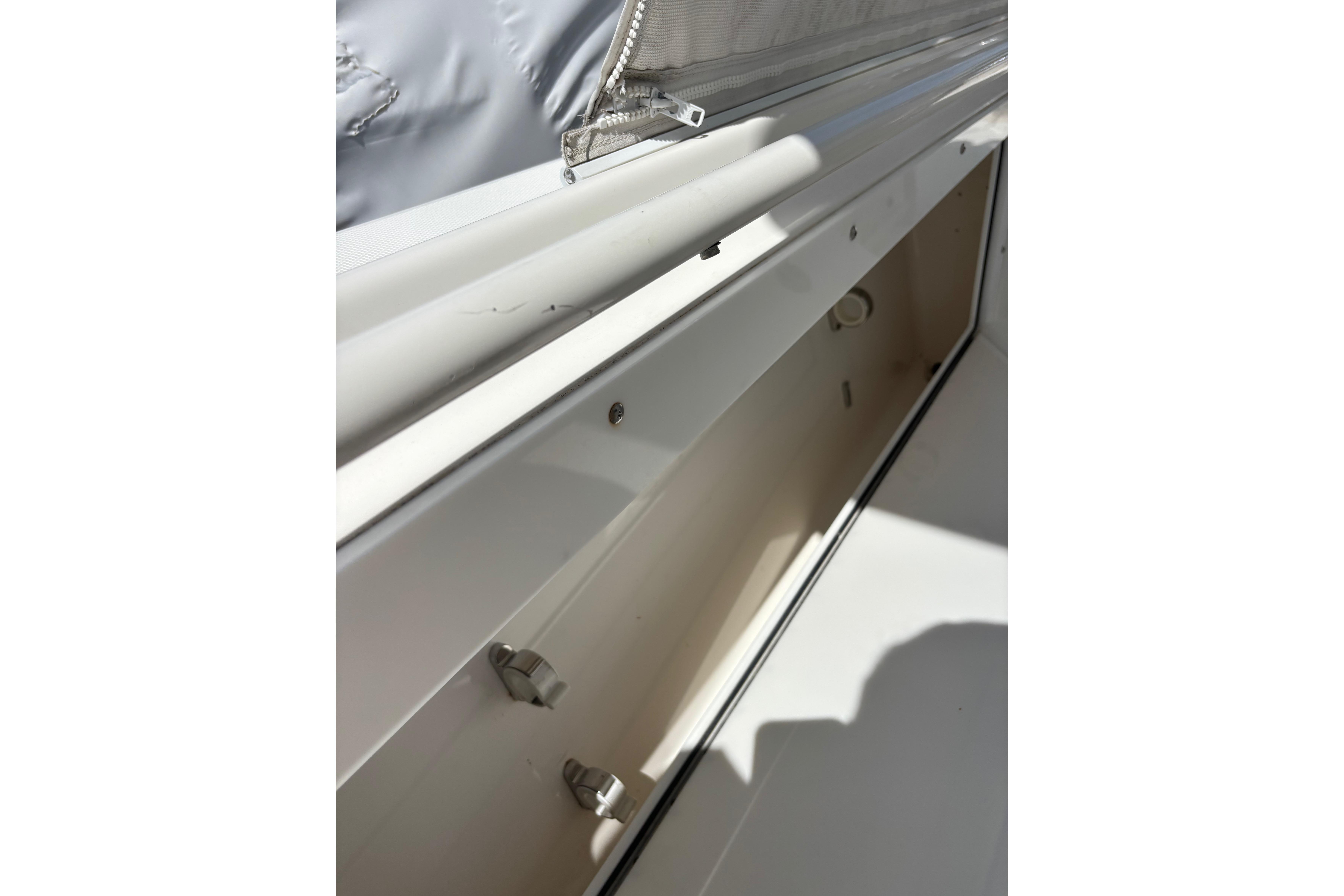Storage compartment on a 2006 Edgewater 318CC boat, showcasing interior details.