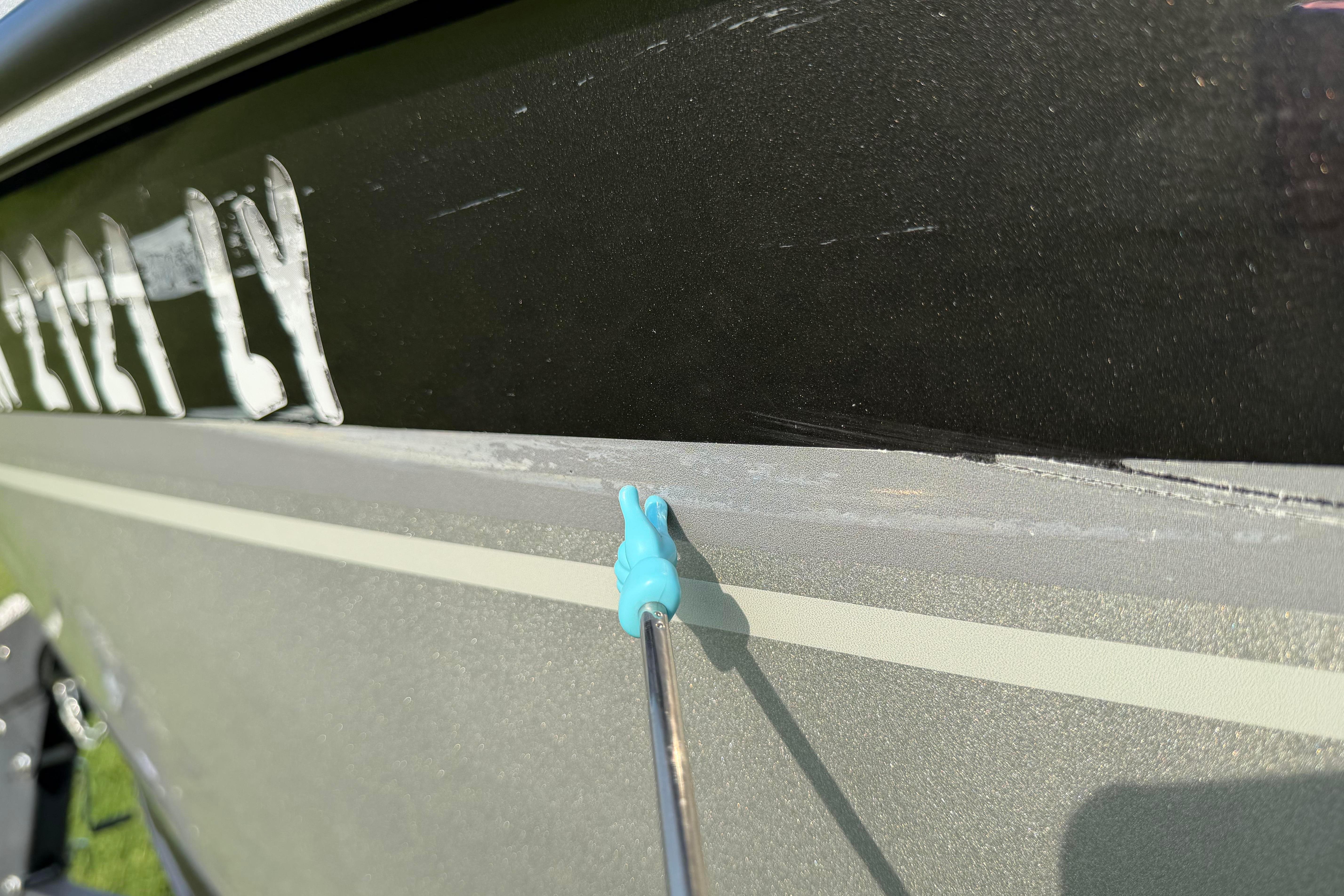 Close-up of 2019 Alumacraft Trophy 205 boat with a blue tool on the hull.