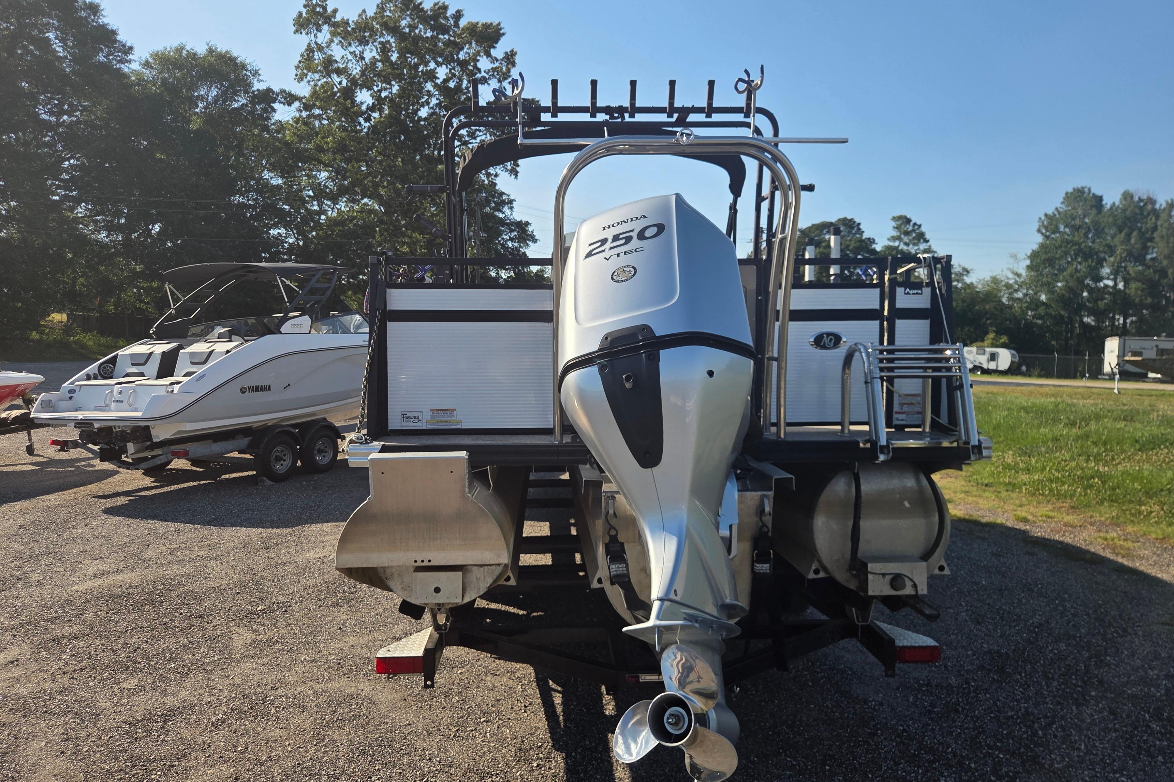 2024 Angler Qwest 8526 Pro Troll boat with Honda 250 VTEC engine, parked outdoors.