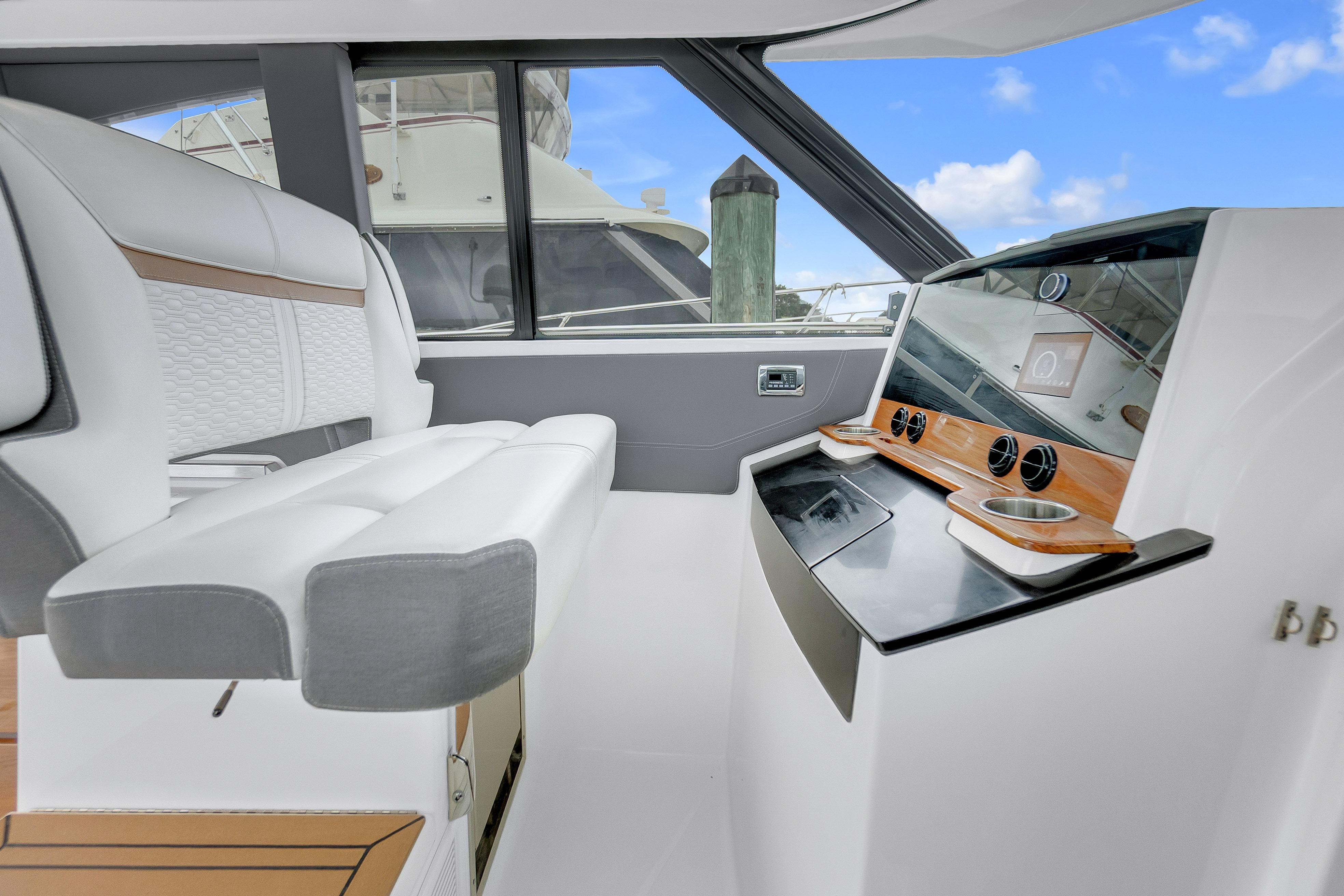 Interior of 2021 Tiara Sport 43 LE yacht with modern helm and seating.