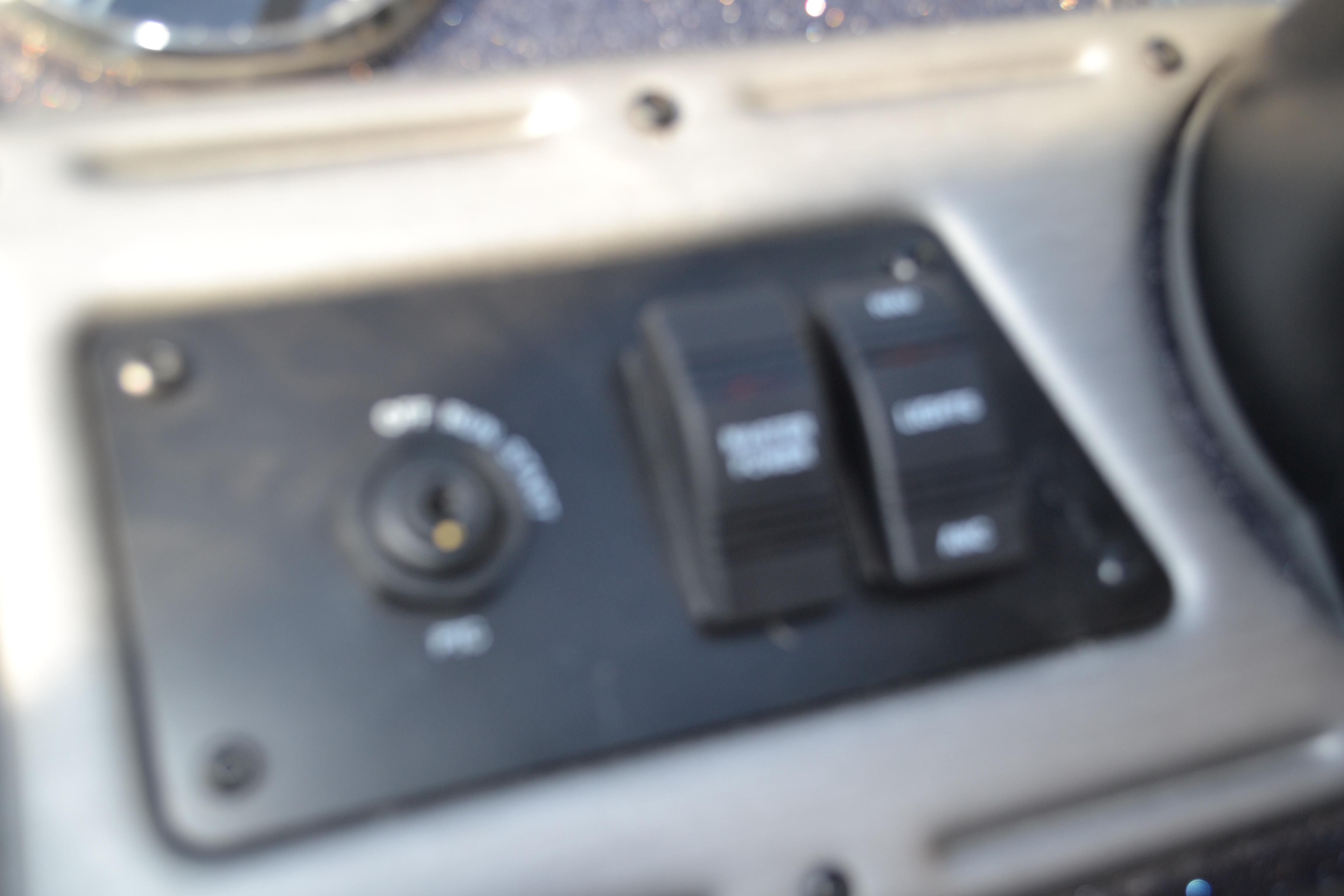 Control panel of 2026 Ranger VS1882SC Reata boat, featuring switches and ignition.