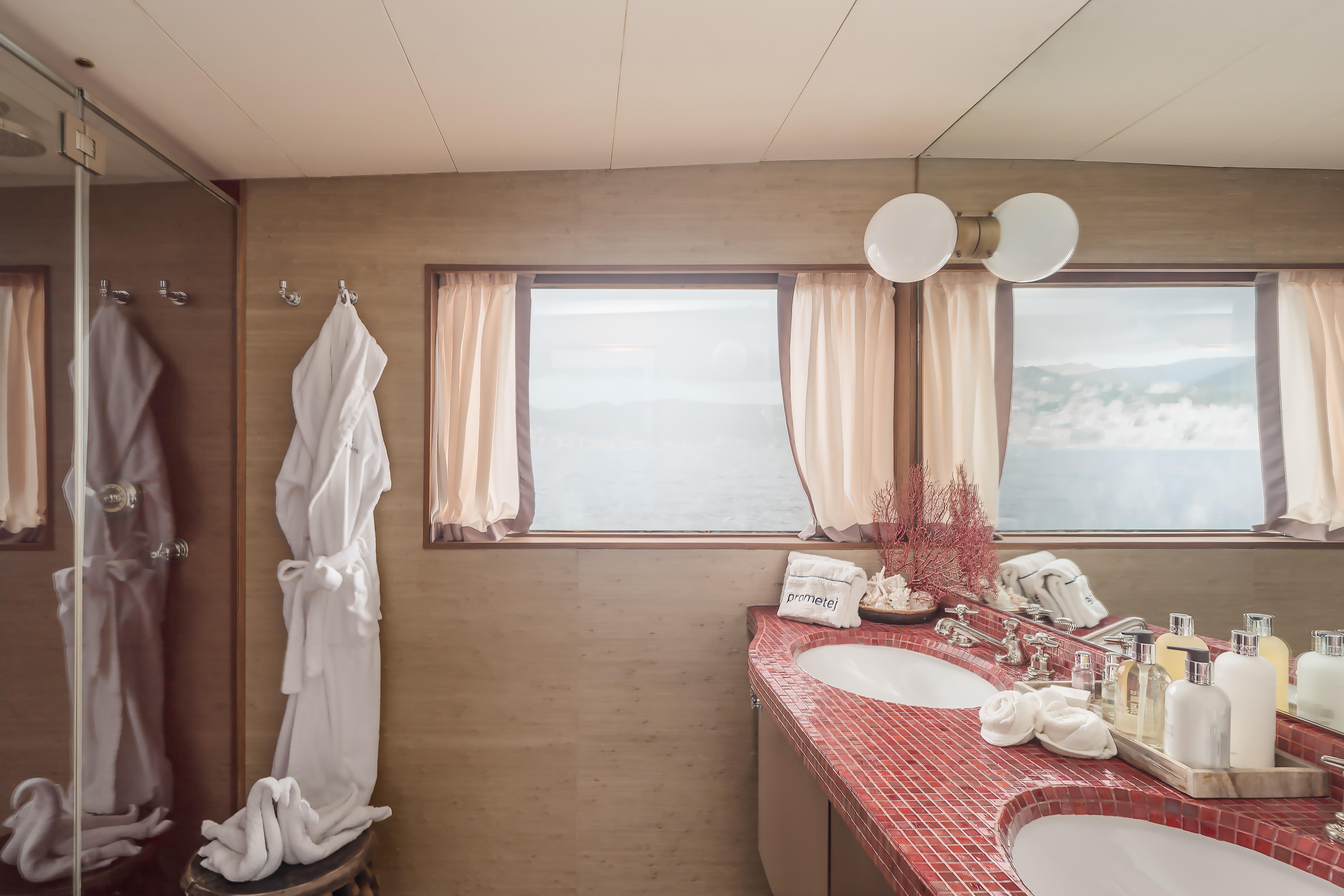Luxurious bathroom on a 1956 custom converted tugboat with ocean view and elegant decor.