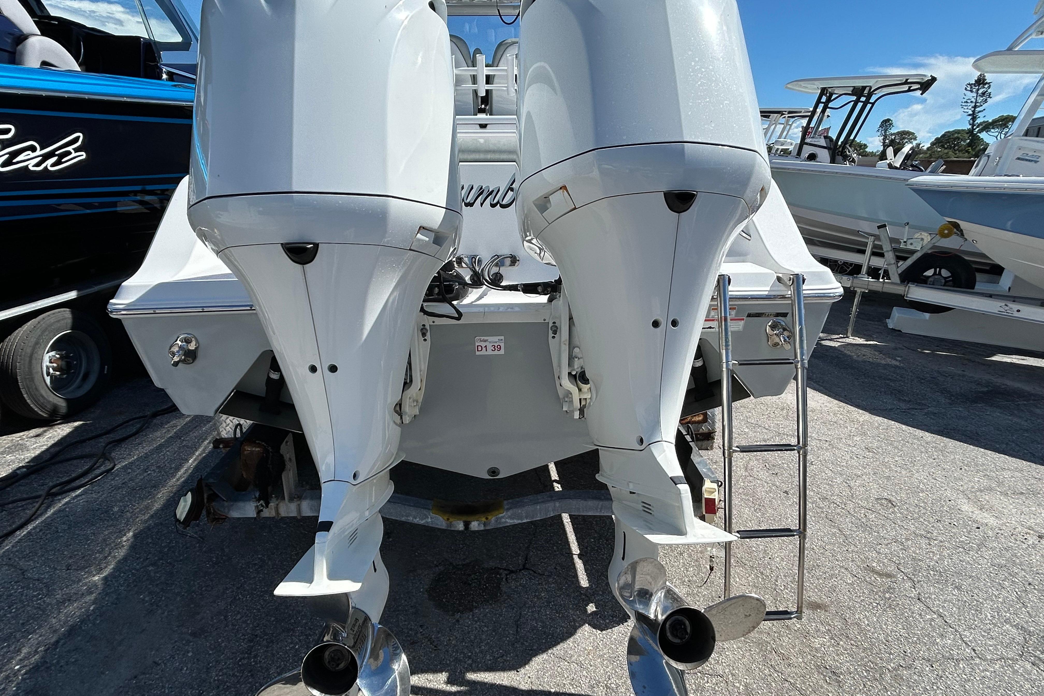 2019 Sportsman Open 282 Center Console with dual outboard motors, rear view.