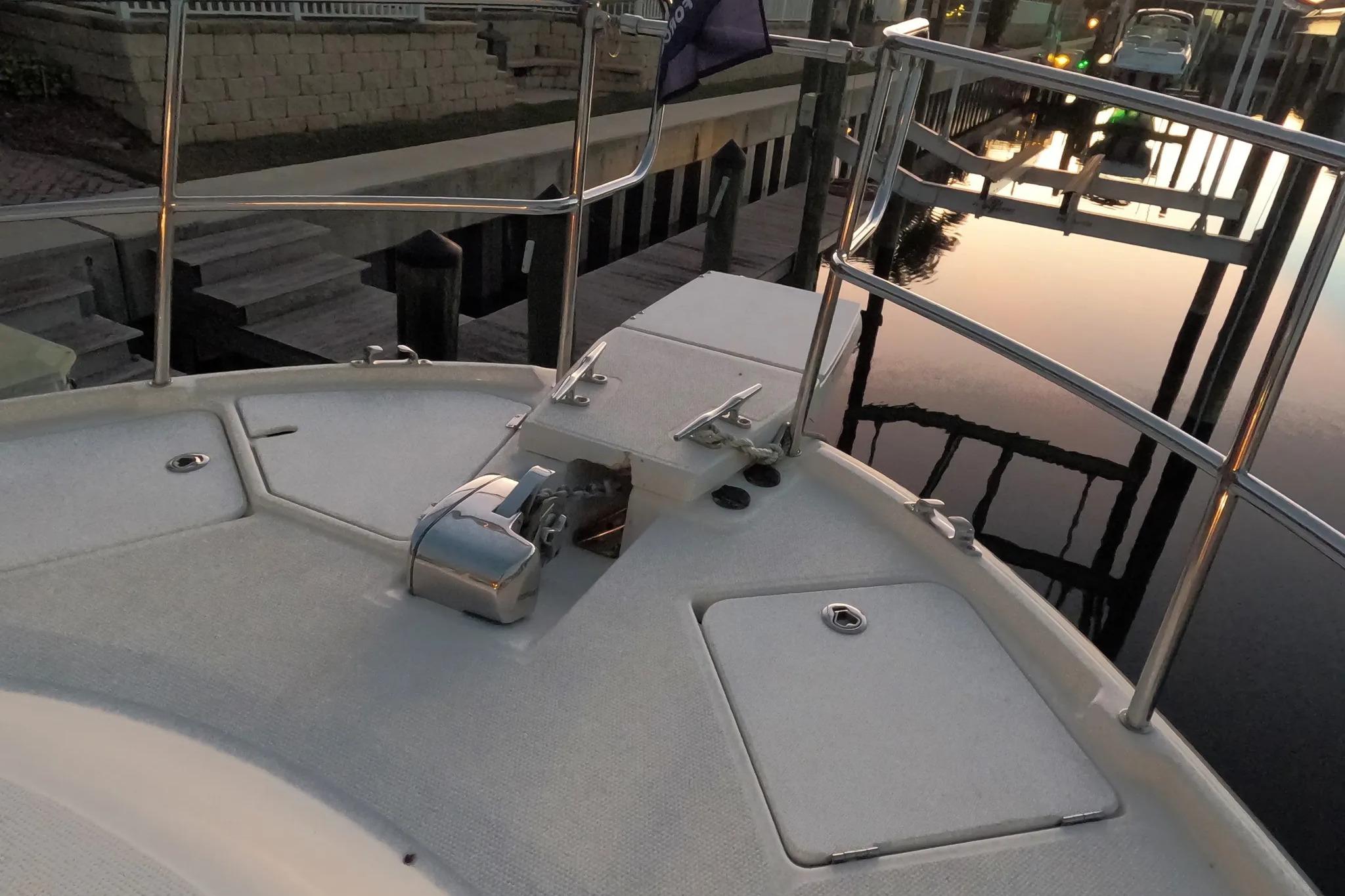 2015 Ranger Tugs R-29 S boat deck with railing and winch at sunset.