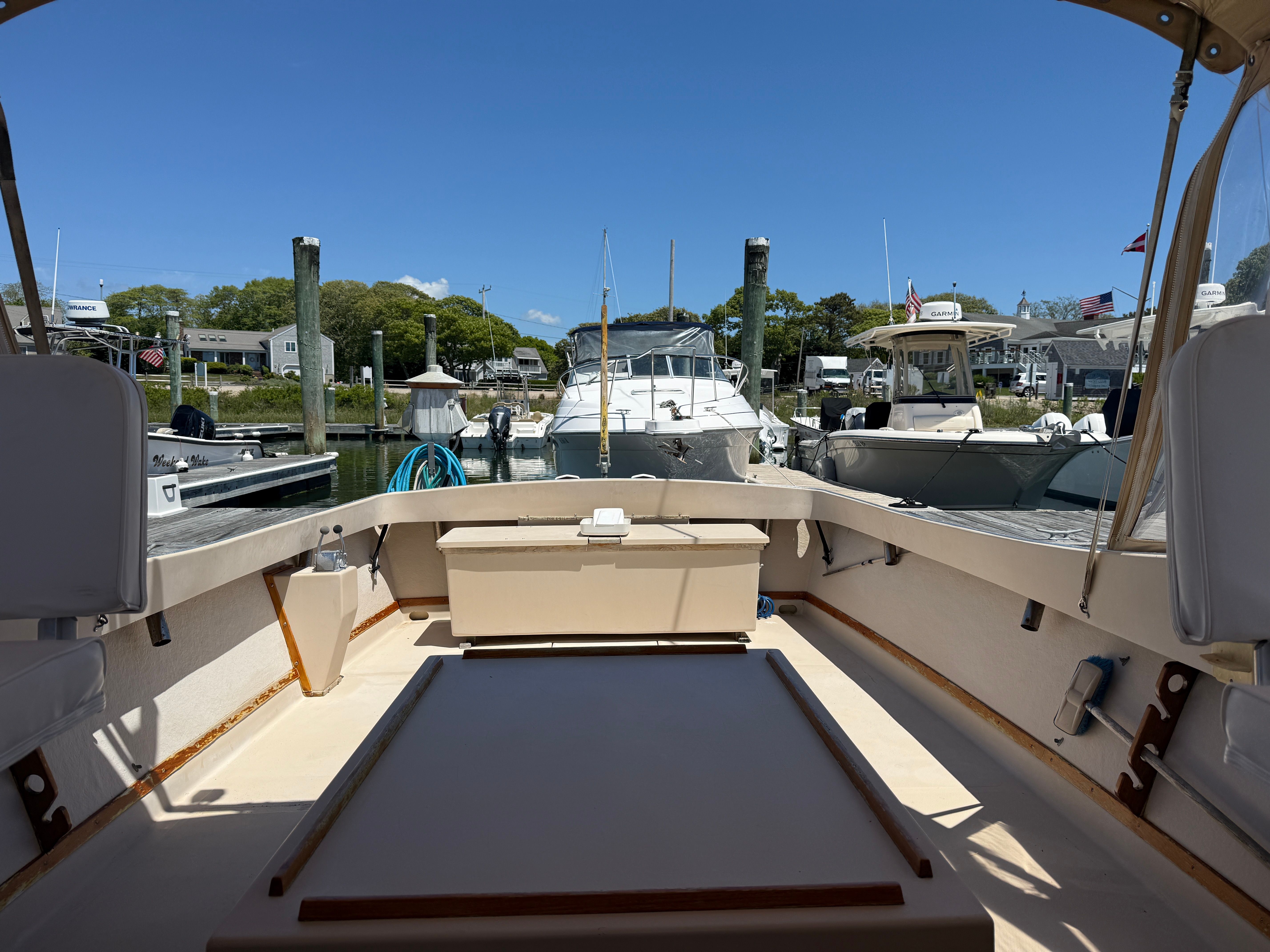 The deck of a 1989 Fortier 26 boat in a calm marina.