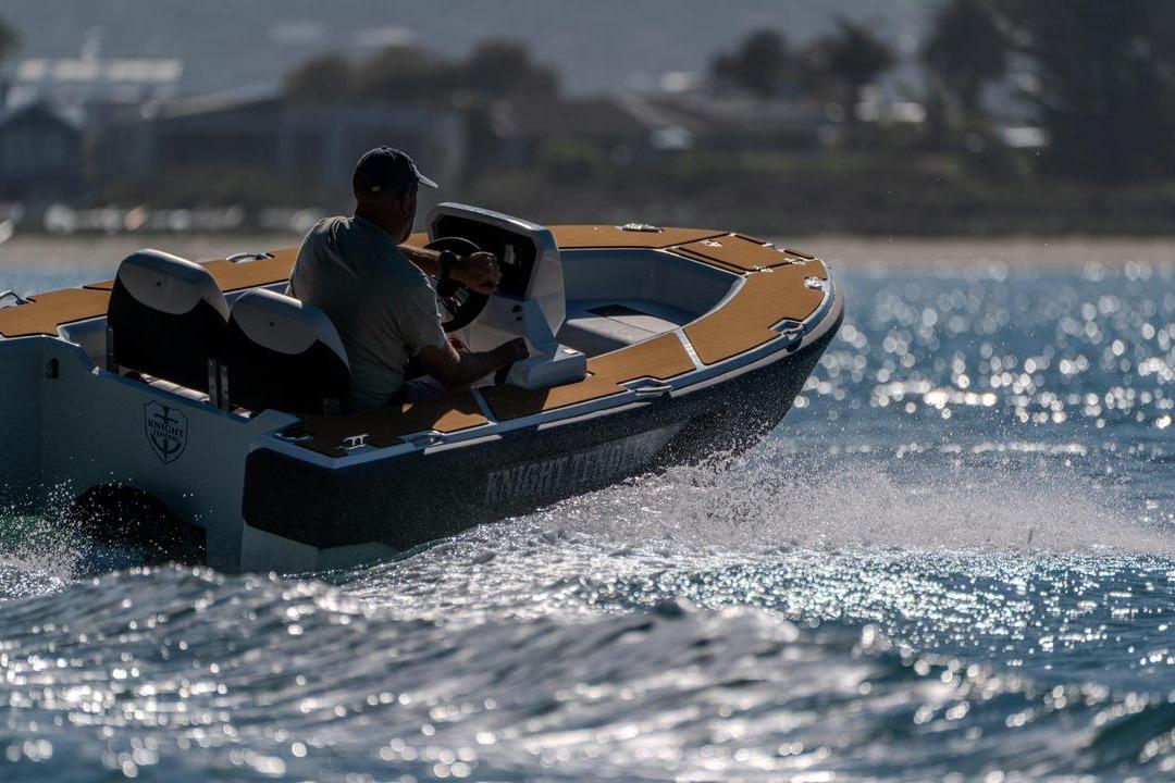 2026 Knight Tender Zerojet Electric Center Console cruising on sparkling water.