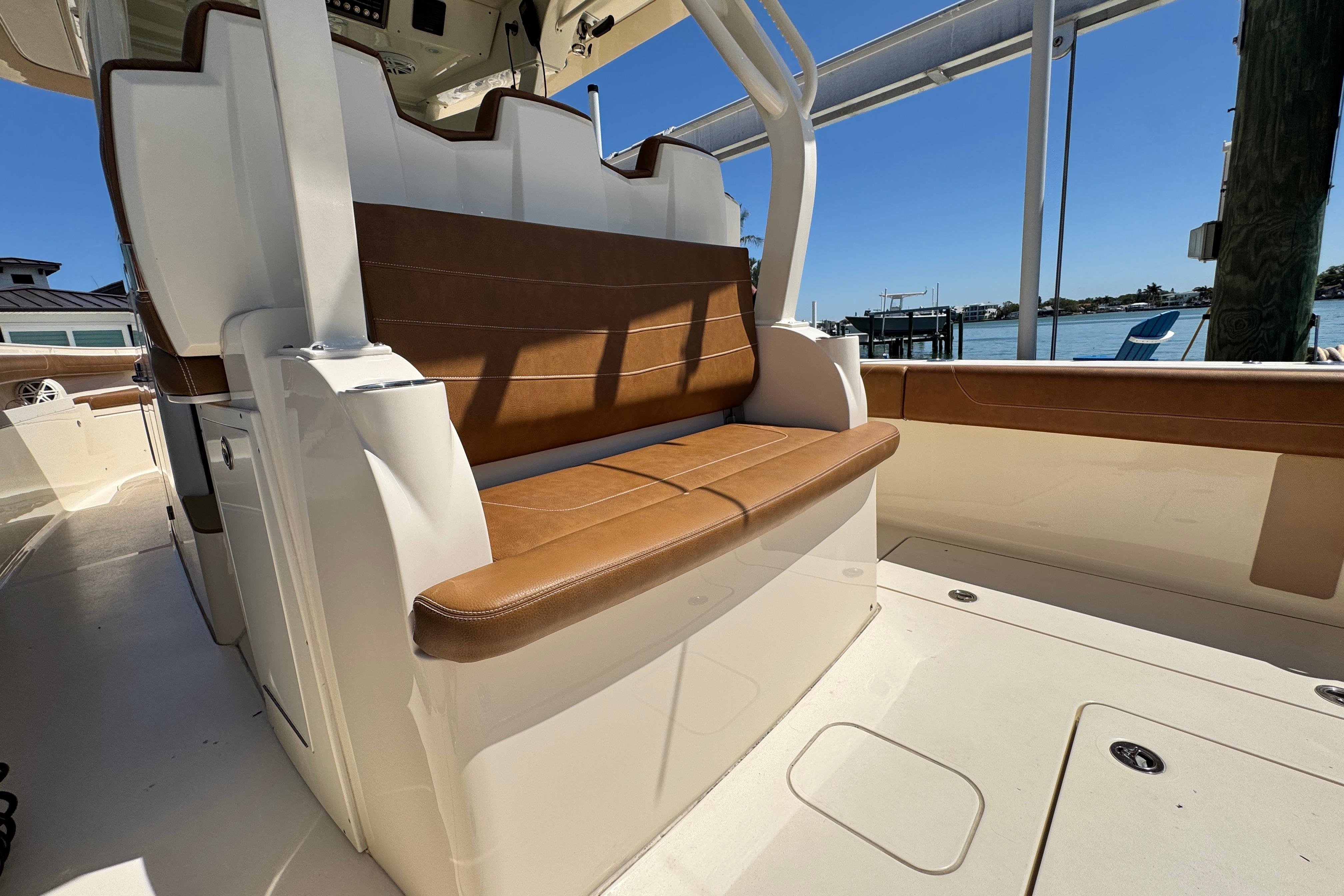 2018 Scout 355 LXF boat interior with brown leather seating, dockside view.