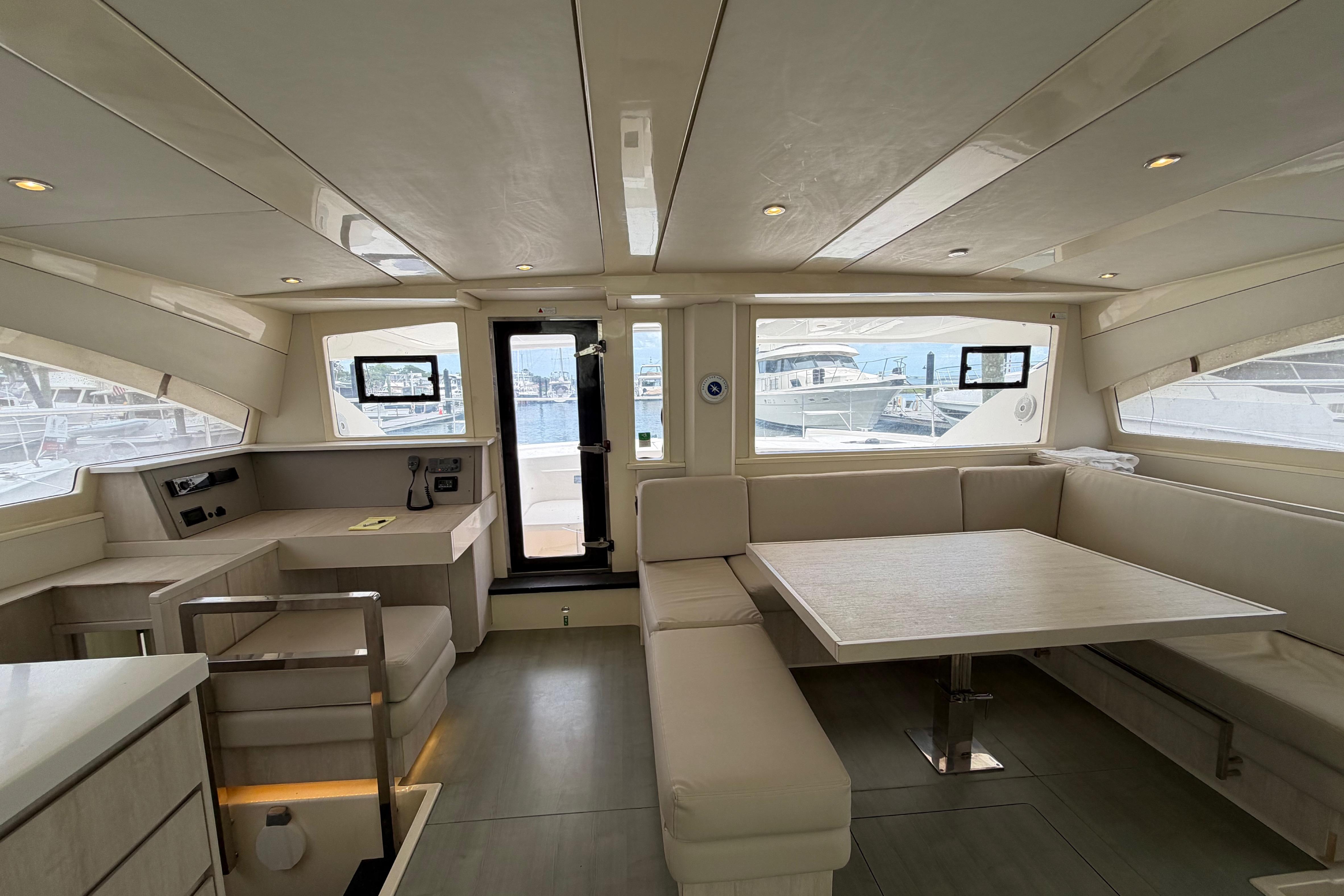 Interior of 2015 Leopard 51 Powercat yacht with modern seating and dining area.