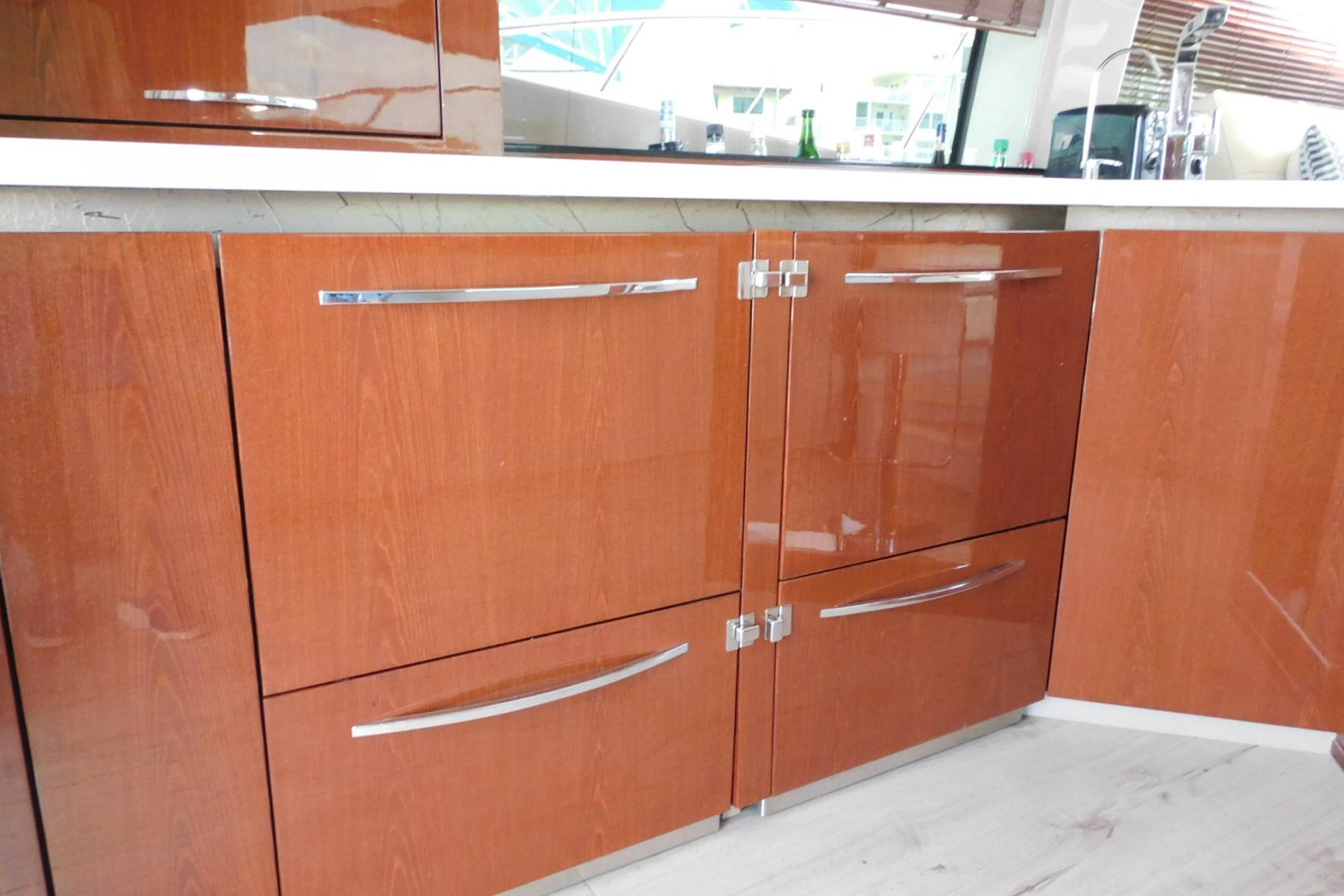 Luxurious wooden cabinetry in the 2019 Sea Ray L550 yacht kitchen.