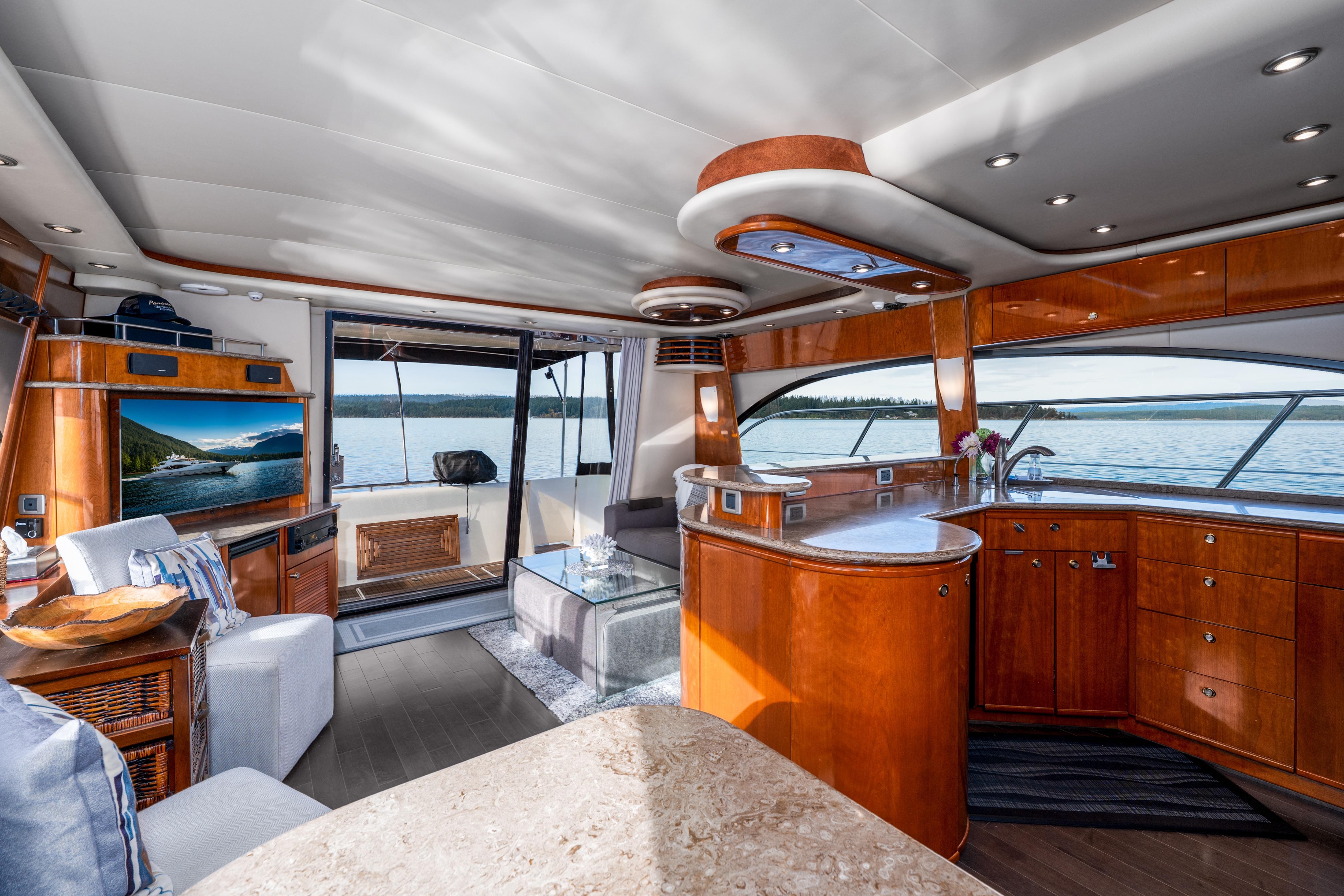 Luxurious interior of 2007 Meridian 580 Pilothouse yacht with elegant wood finishes and scenic views.