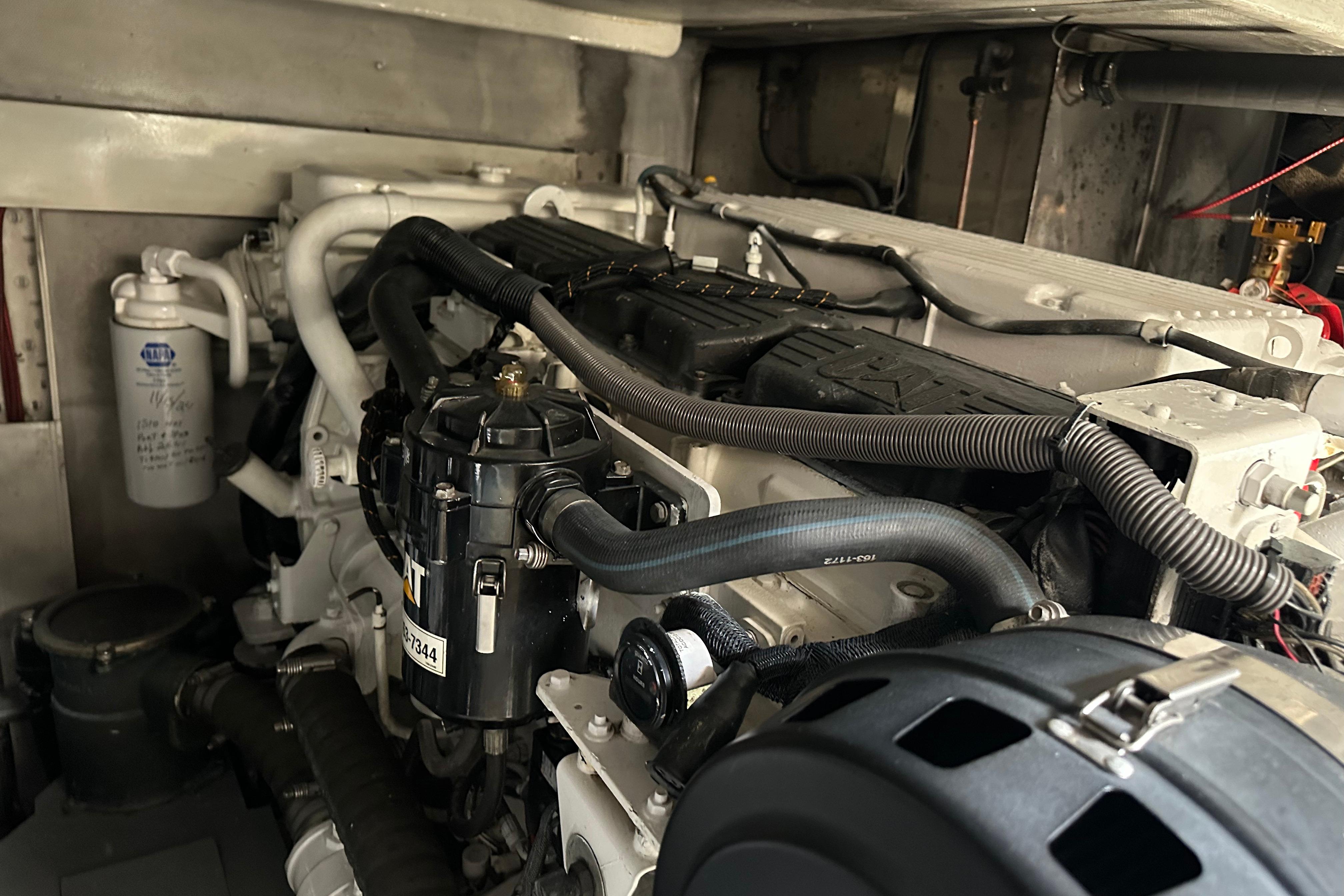 Engine room of a 2004 Azimut 55E yacht, showcasing detailed mechanical components.