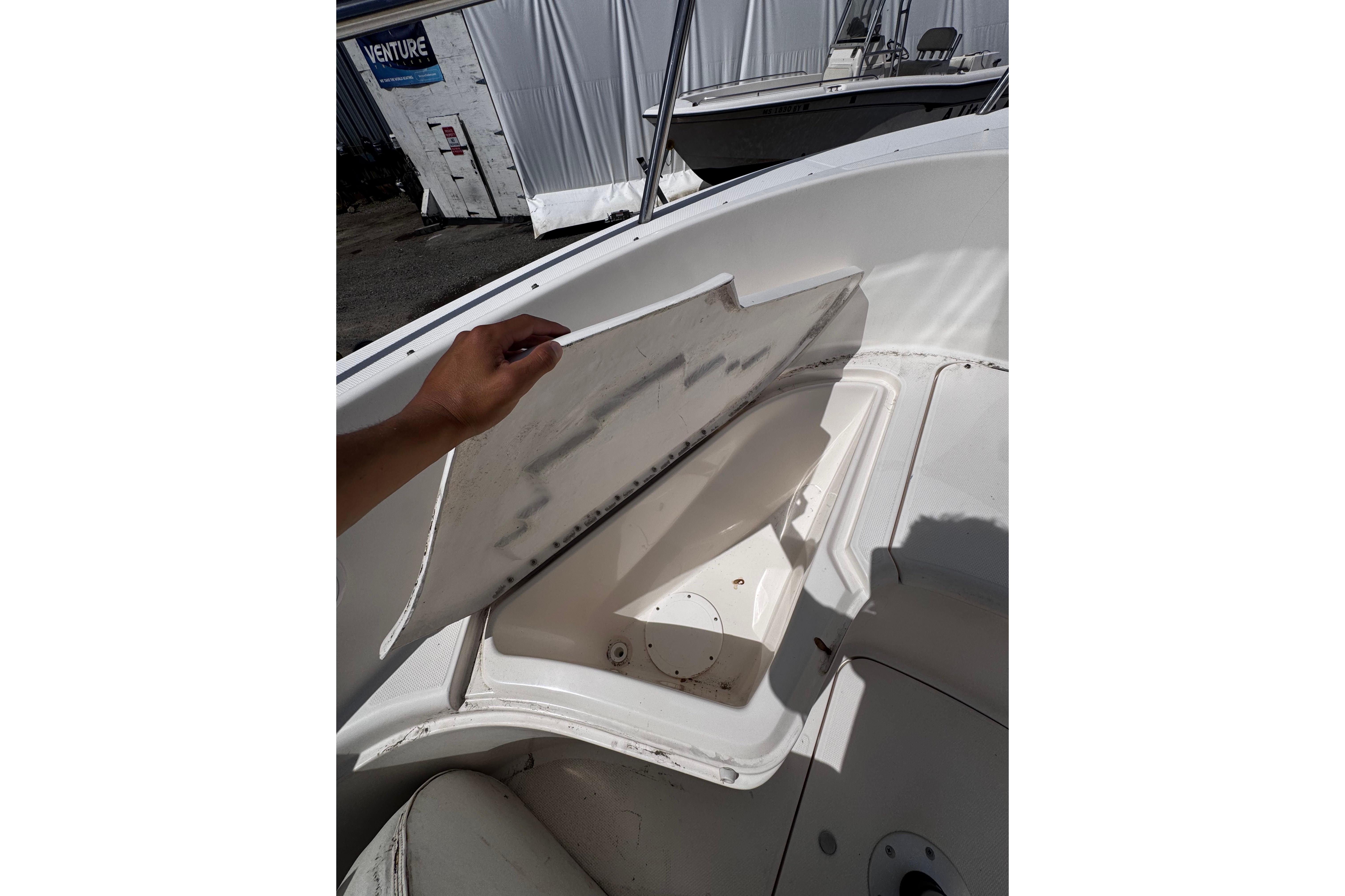 Open storage compartment on 2003 Palm Beach 2200 Dual Console boat.