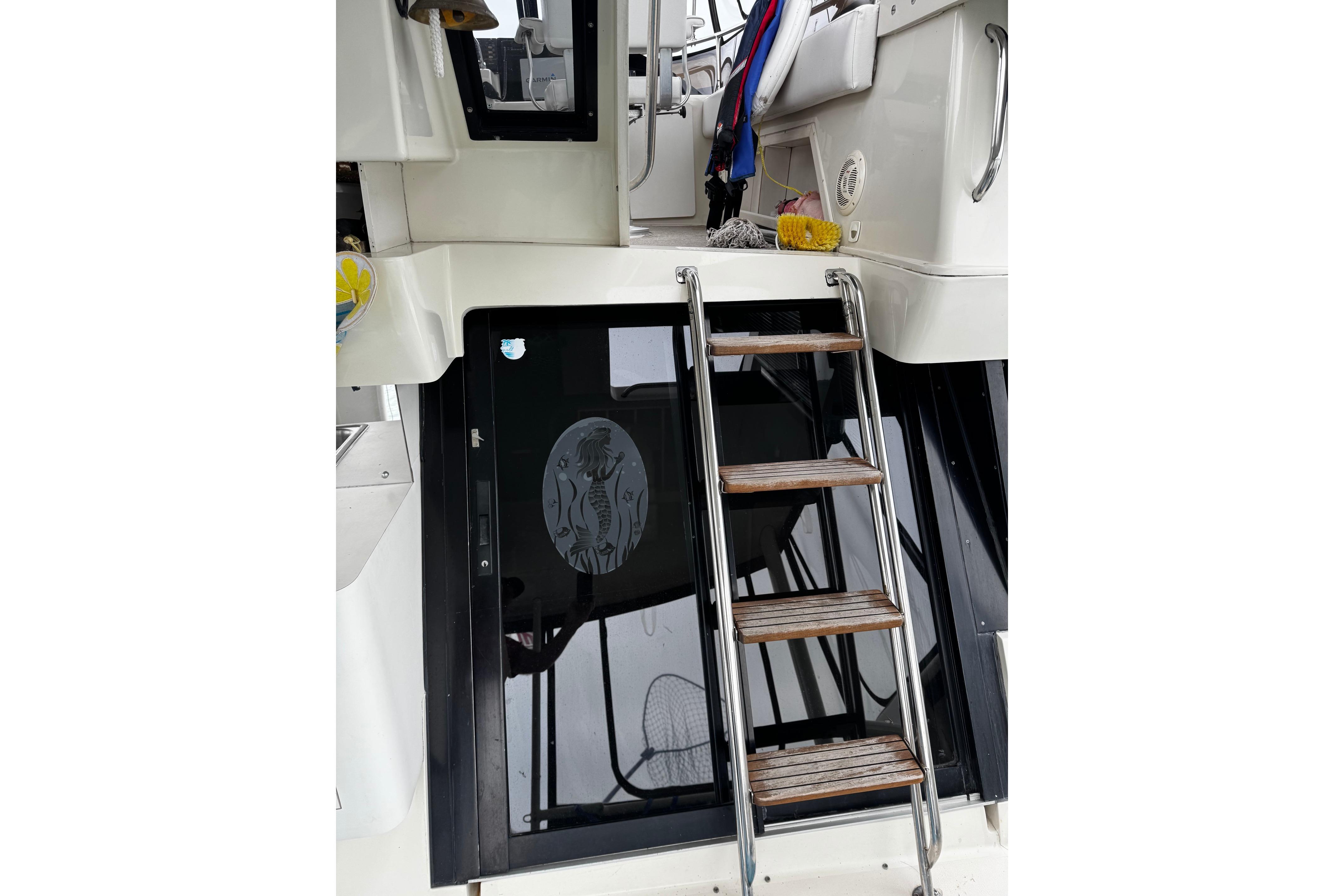 Stainless steel ladder on 1991 Silverton 46 Motor Yacht, leading to upper deck.