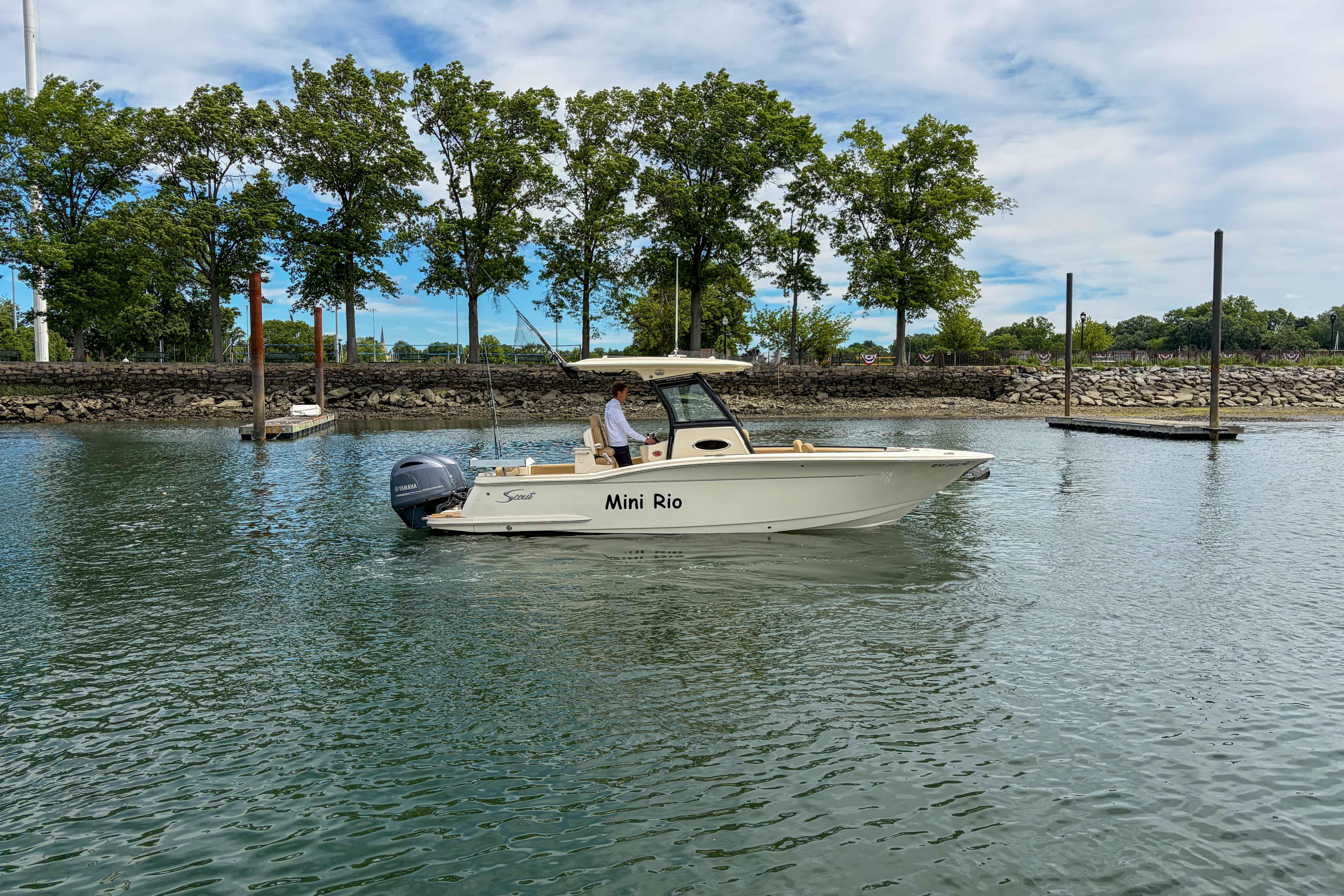 2020 Scout 255 LXF boat named "Mini Rio" cruising on a calm waterway.