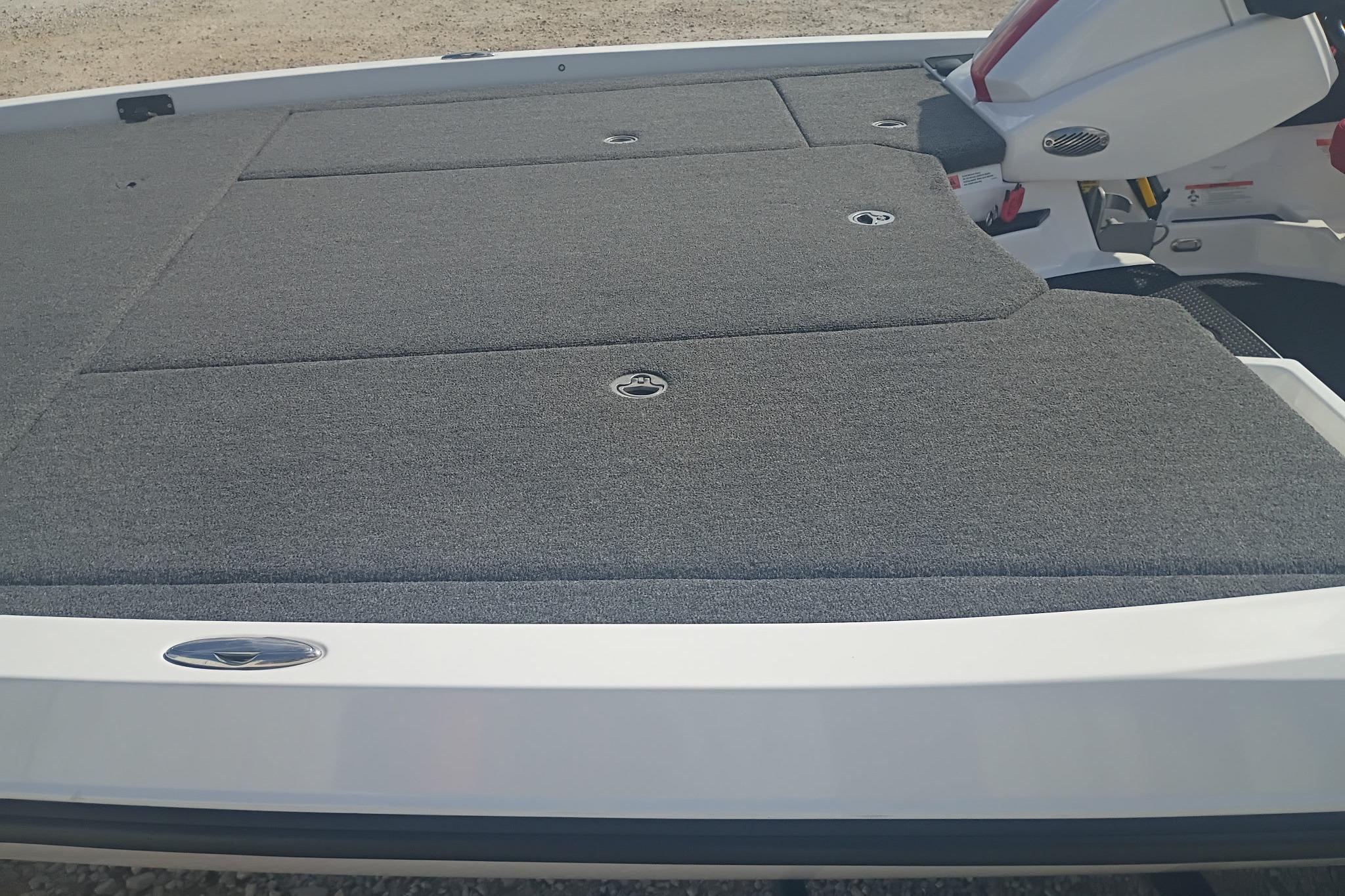 2024 iKon LX21 boat deck with gray carpet and storage compartments.