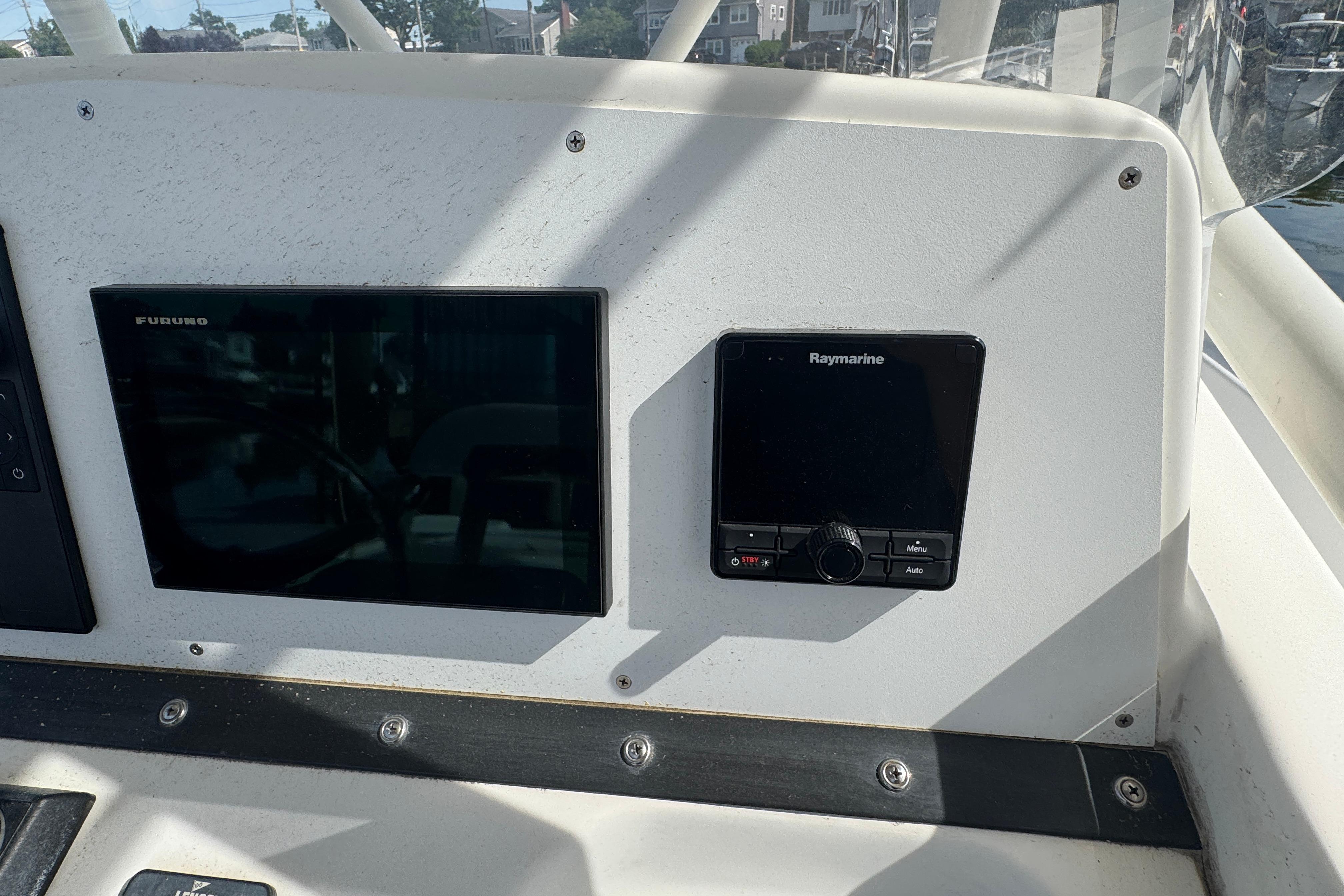 Dashboard of a 2005 Edgewater 265CC boat with Furuno and Raymarine displays.
