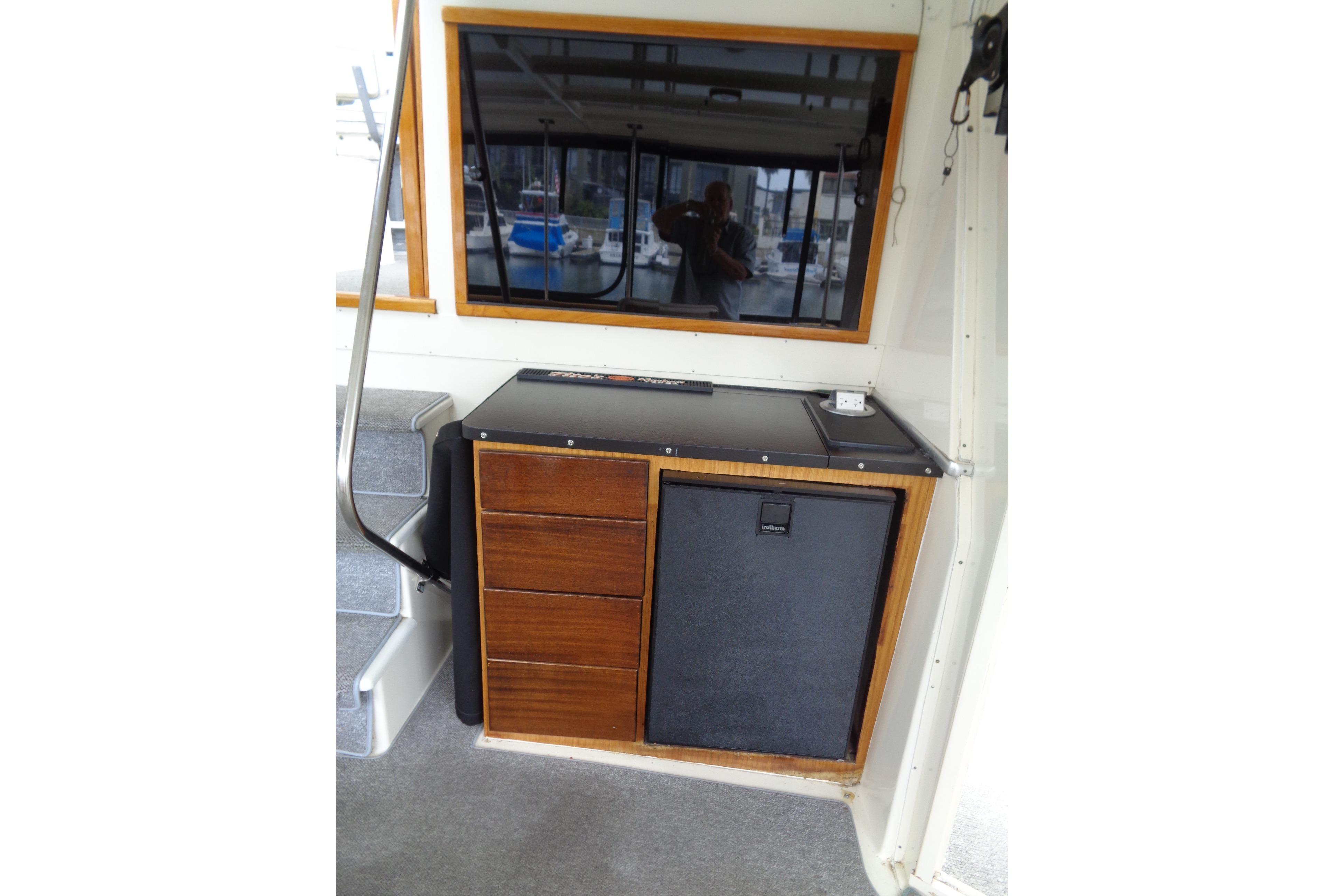 Interior of 1981 Hatteras 48 Cockpit Motor Yacht with wooden cabinetry and stairs. Sun Deck