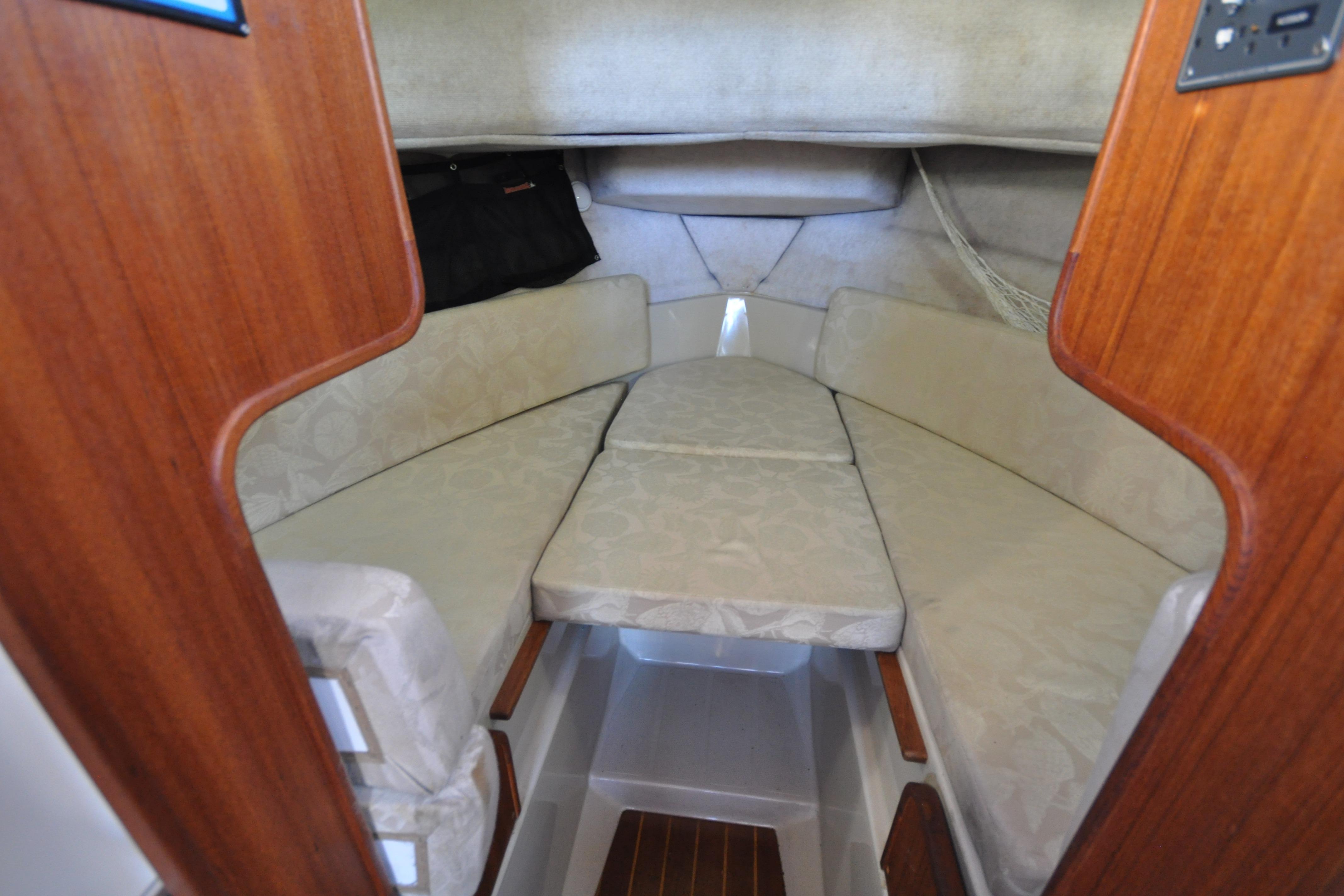 2007 Ranger Tug R-25 cabin interior with cushioned seating and wooden accents.