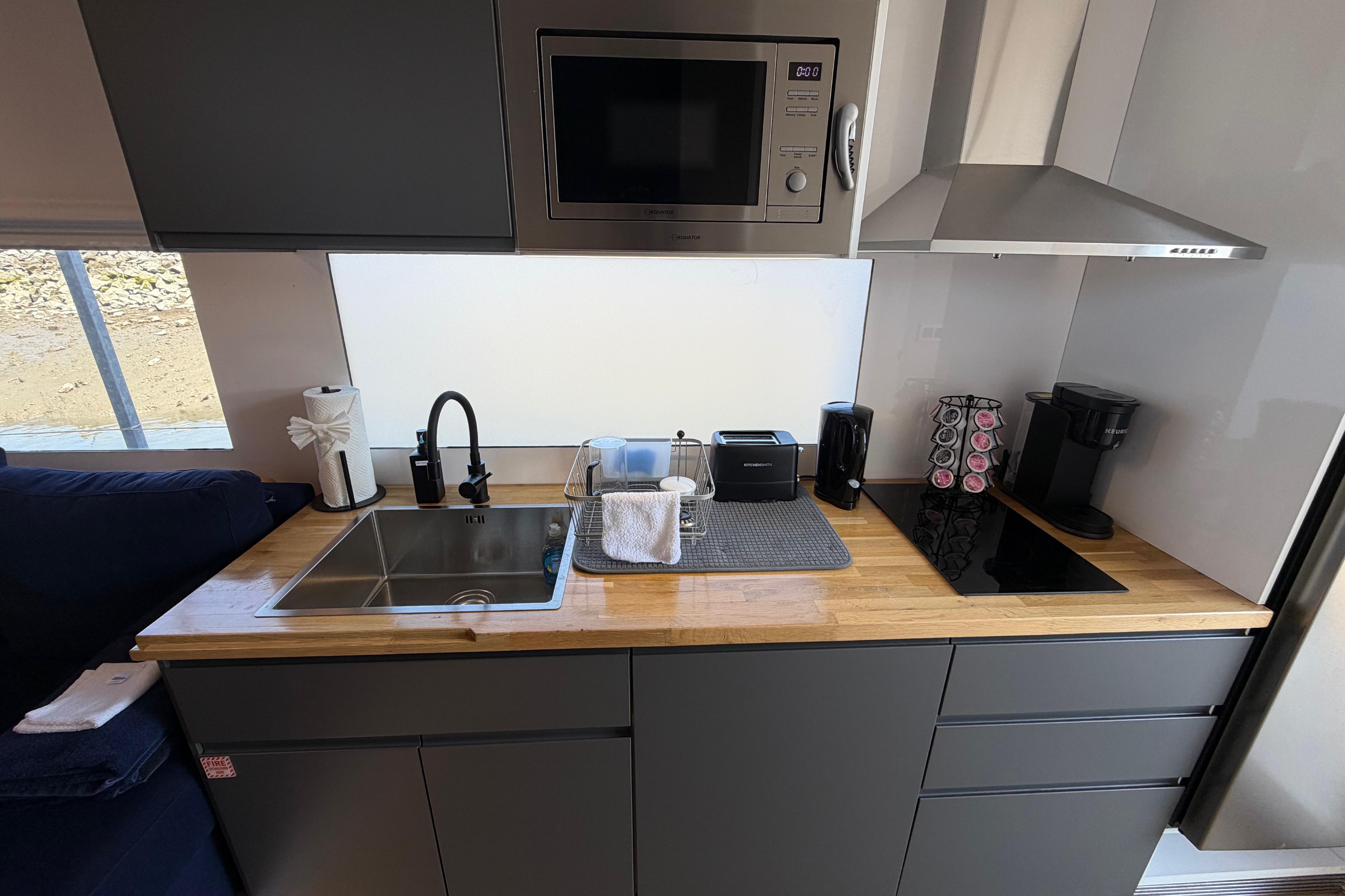 Modern kitchen in 2022 Navisyo NV.08 with sleek appliances and wooden countertop.
